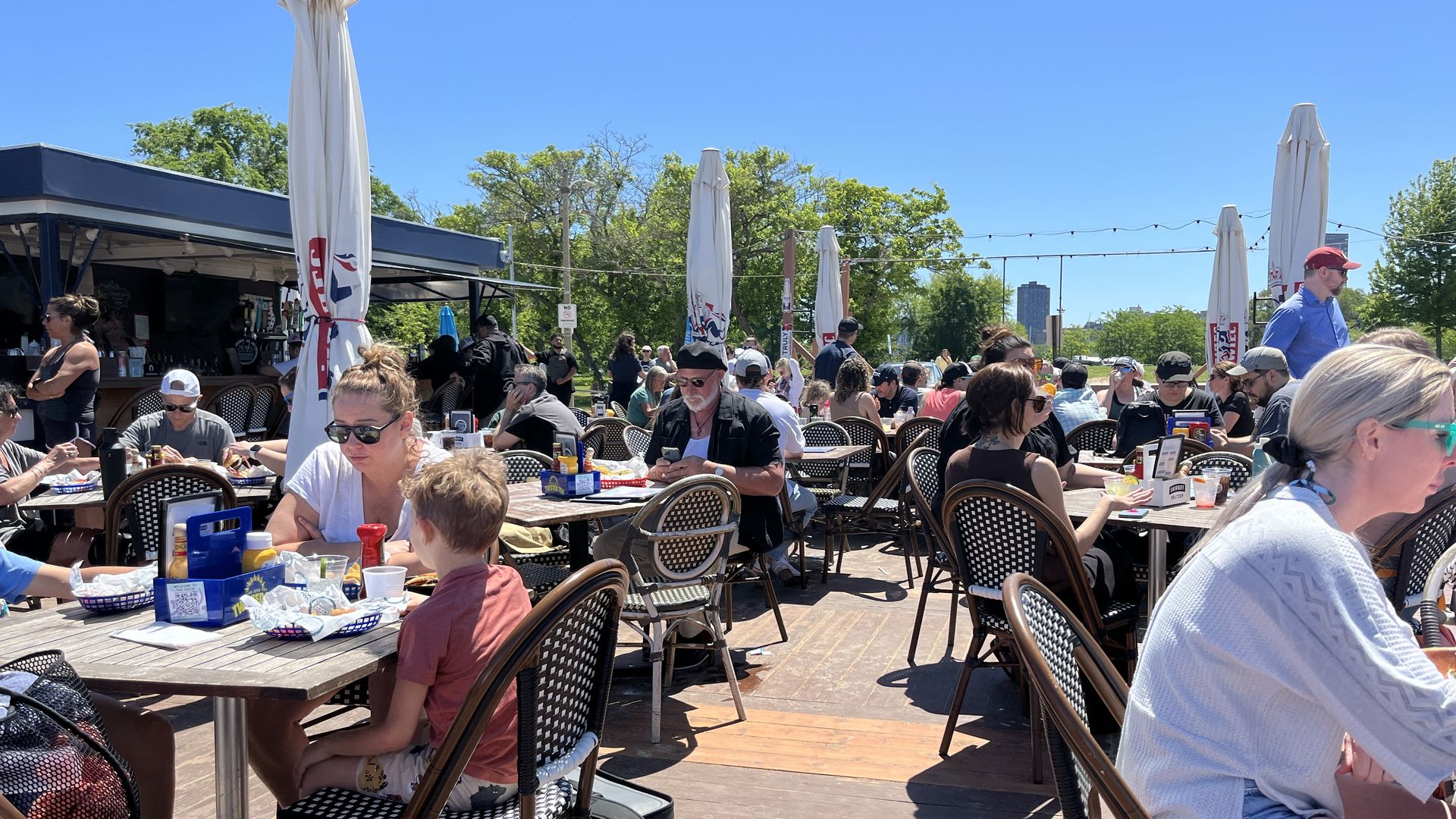 Photo of people eating at a restaurant outside 