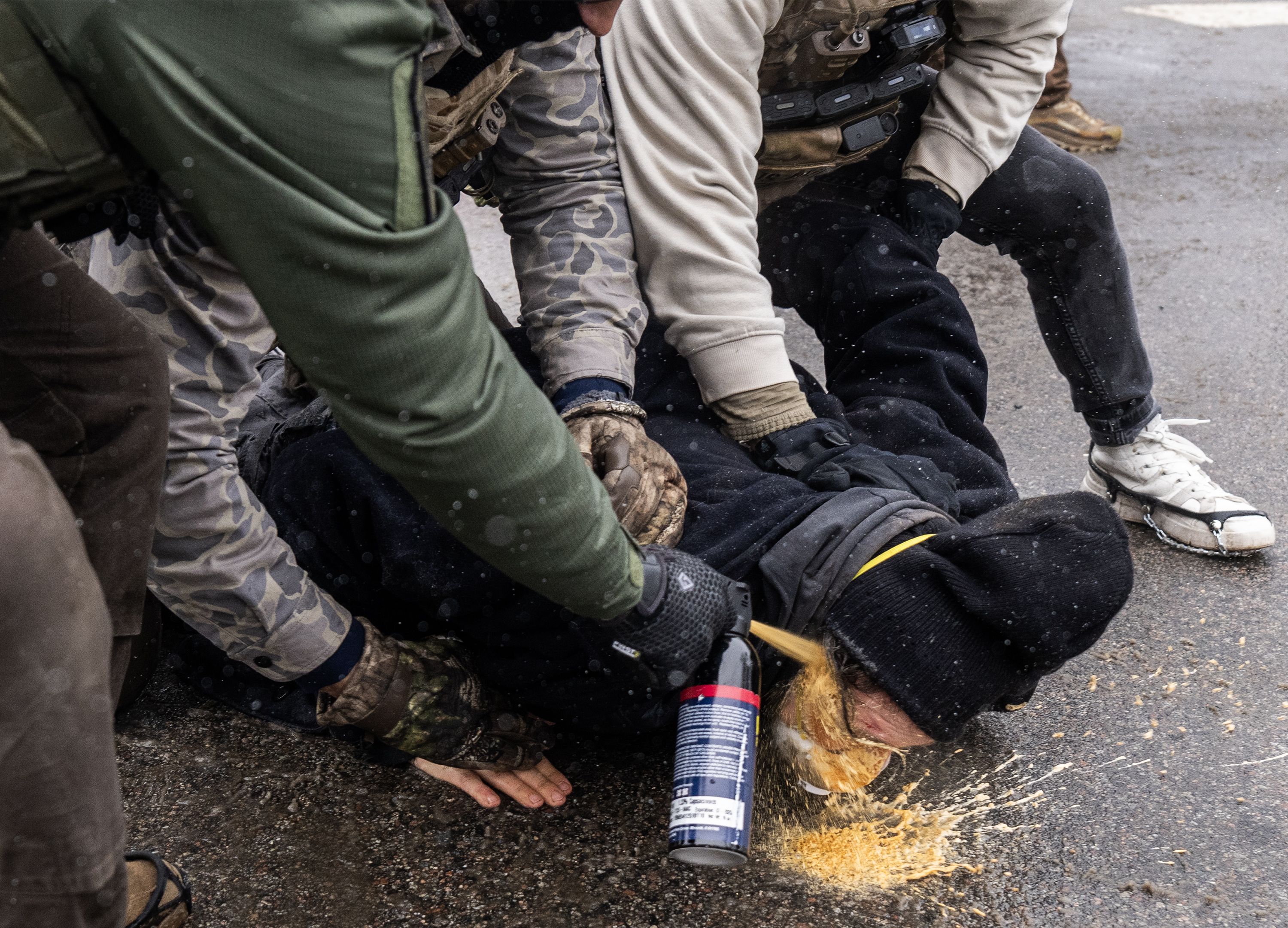 This image, captured Wednesday, of agents spraying chemical irritant into the face of a man who was already pinned down went viral. Photo: Richard Tsong-Taatarii/The Minnesota Star Tribune via Getty Images📷