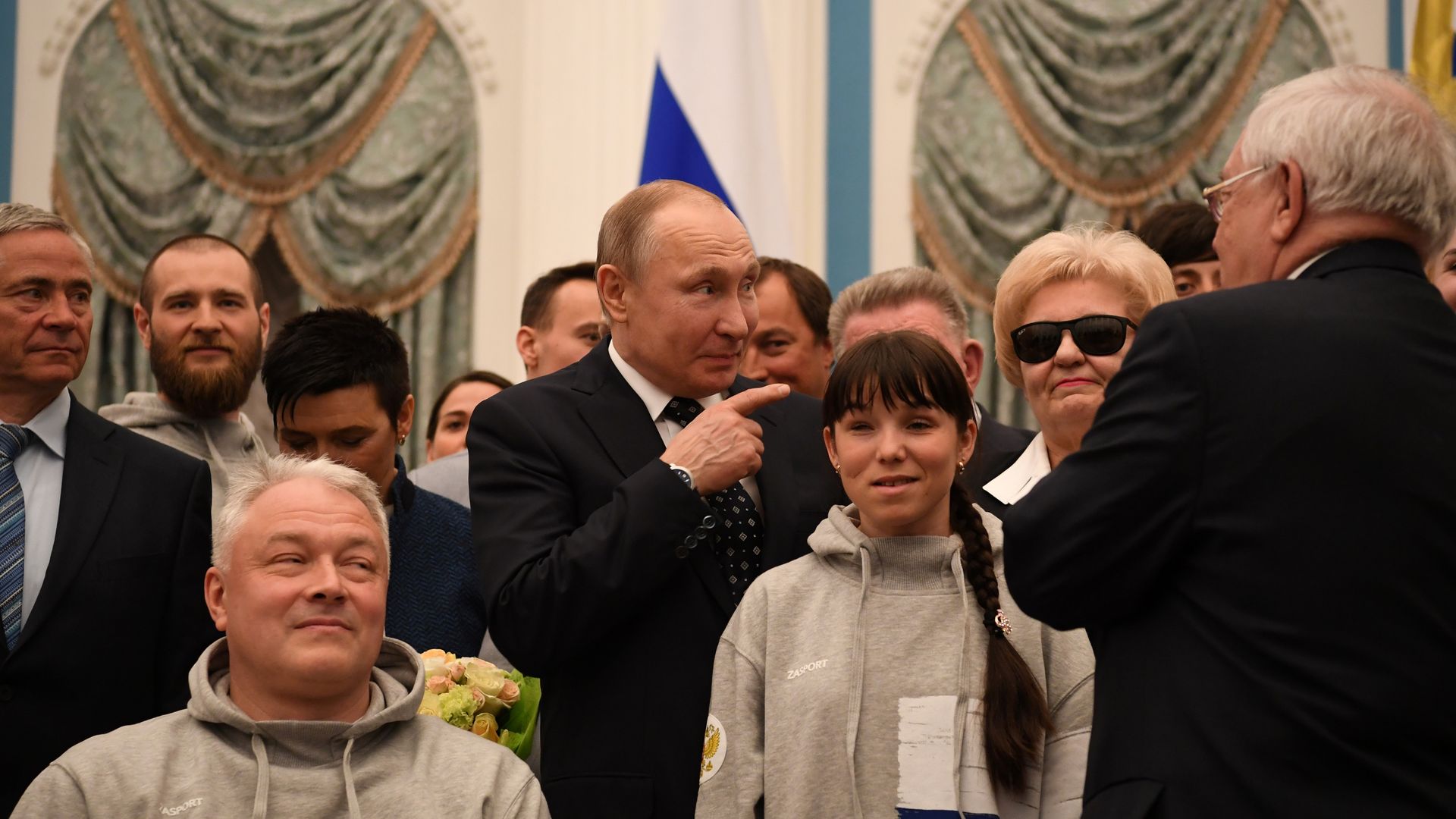 Russian President Vladimir Putin poses with medalists of the 2018 Pyeongchang Winter Paralympic Games