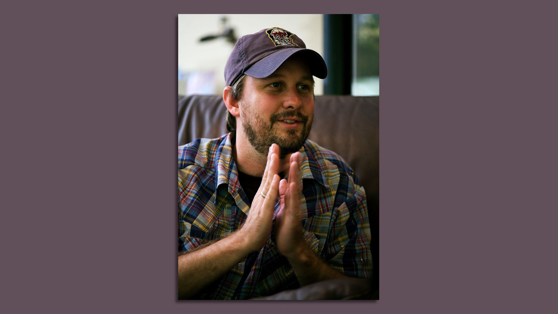 Matt Logelin wears a Twins hat and clasps his hands