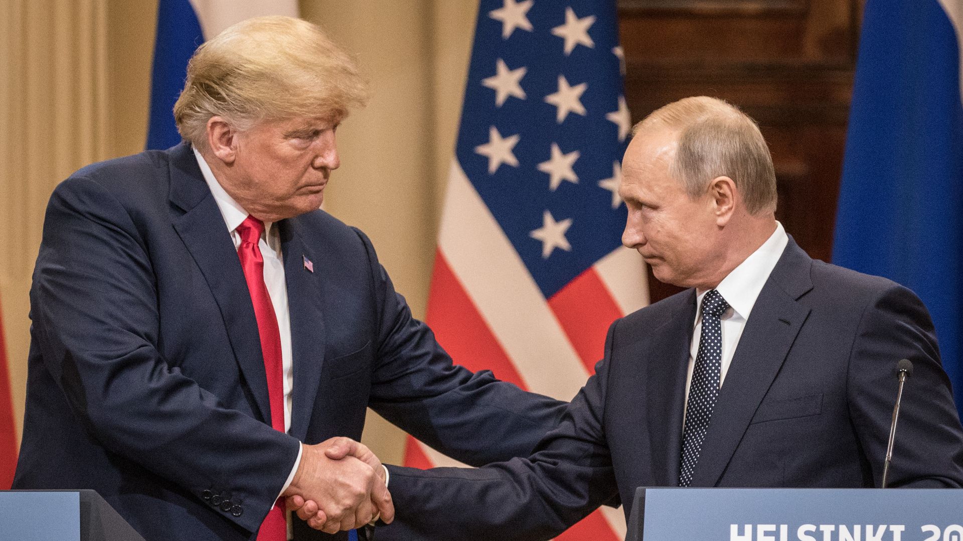 Putin shaking hands with Trump in Helsinki