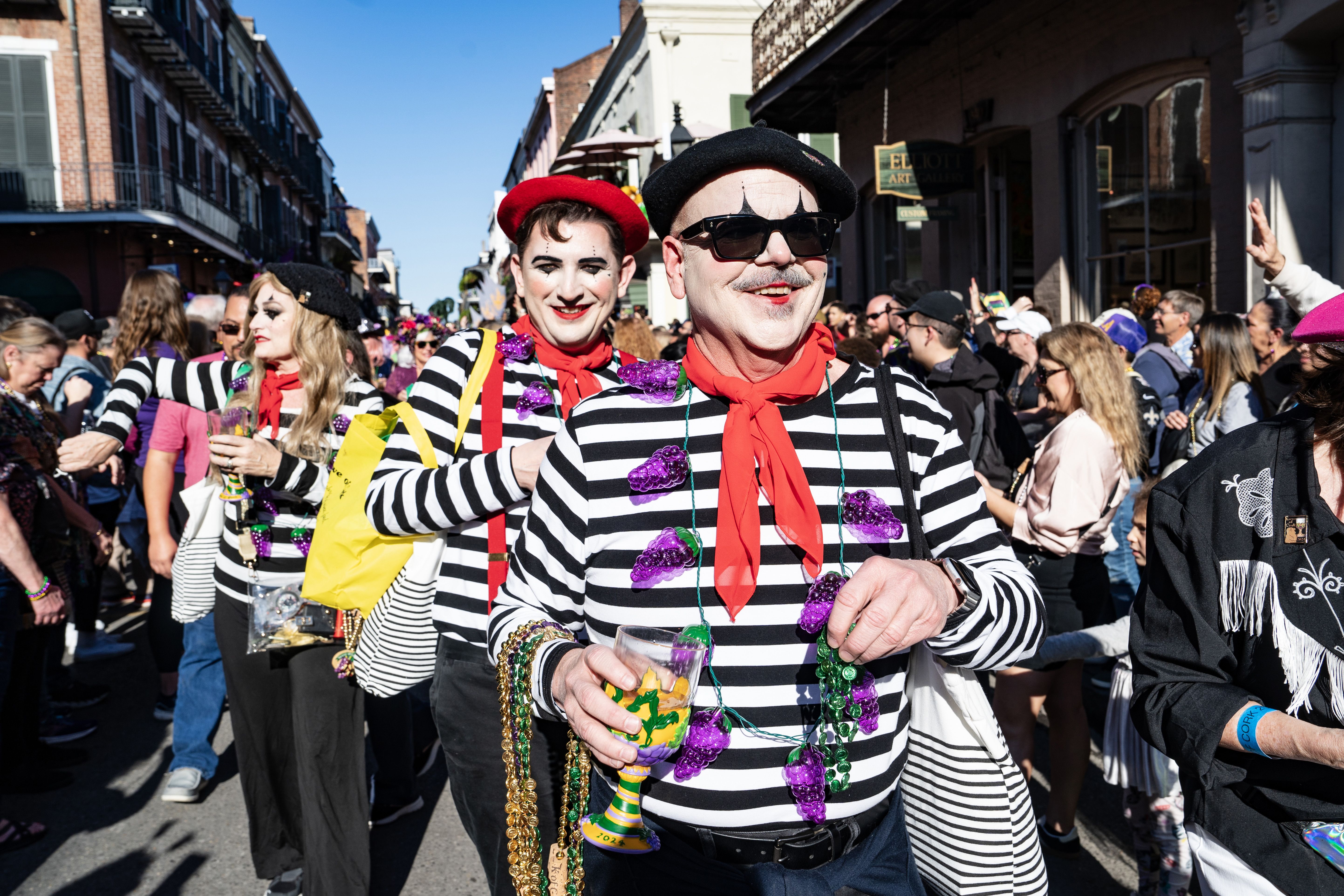 French mime-dressed revelers parade in the French Quarter.