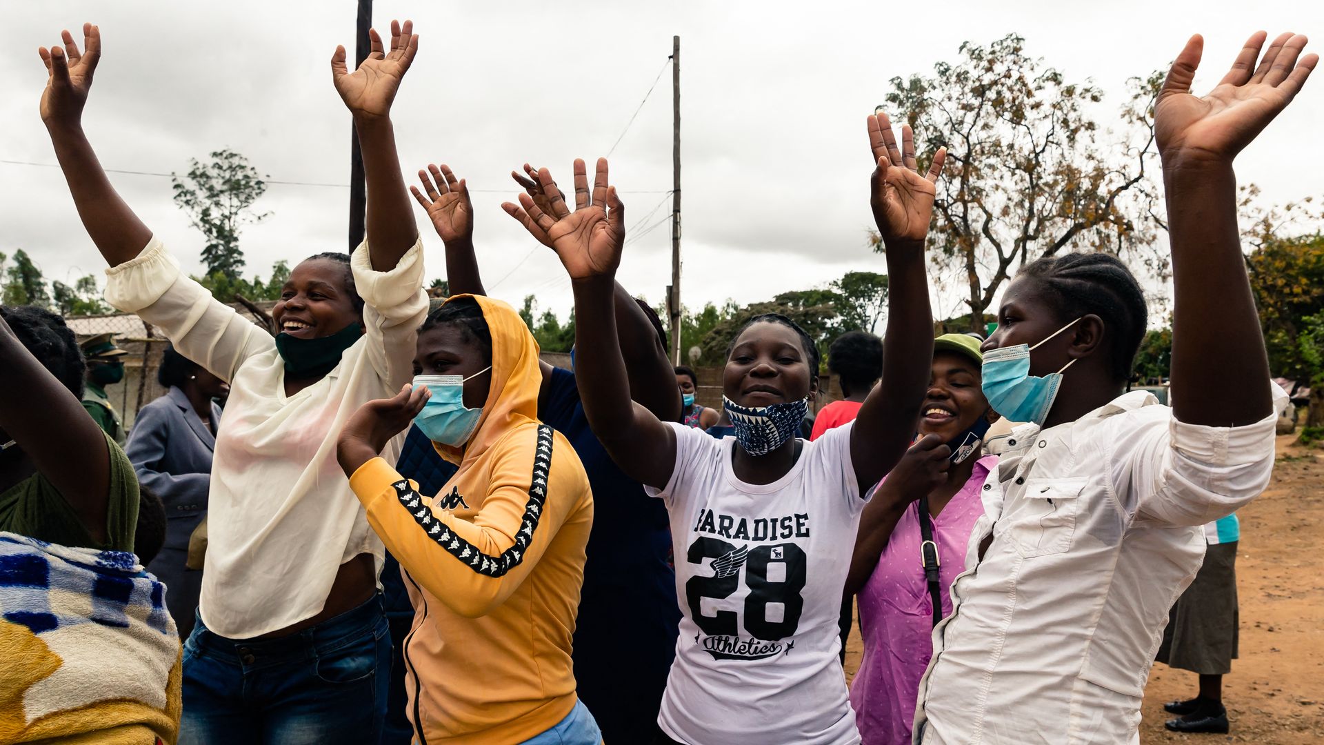 Prisoners wave at their former inmates after walking free from Chikurubi Female Prison in Harare. Photo: Jekesai Njikizana/AFP via Getty Images