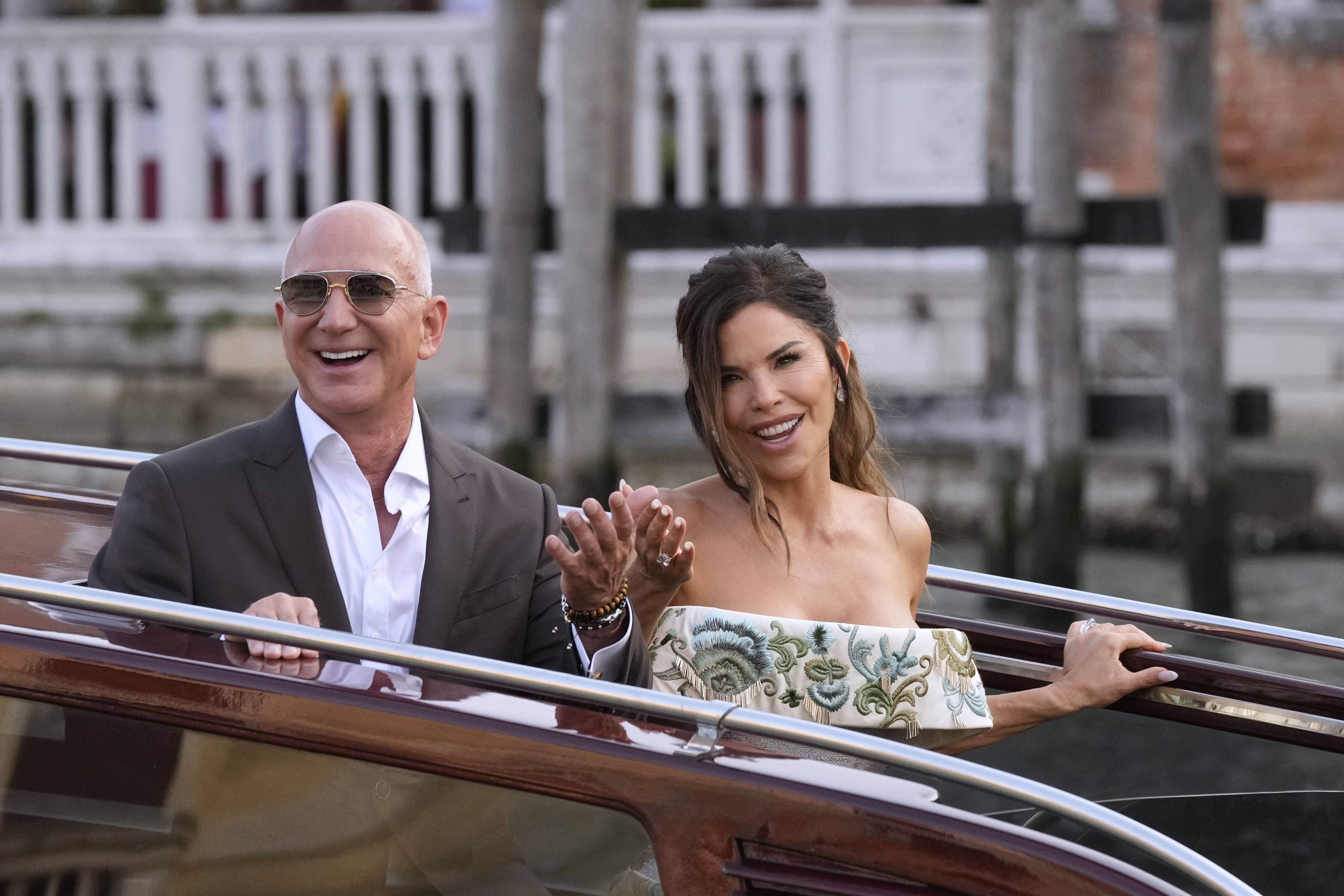 Jeff Bezos, left, and Lauren Sanchez leave a hotel for their pre wedding reception, in Venice, Italy, Thursday, June 26, 2025. (AP Photo/Luca Bruno)