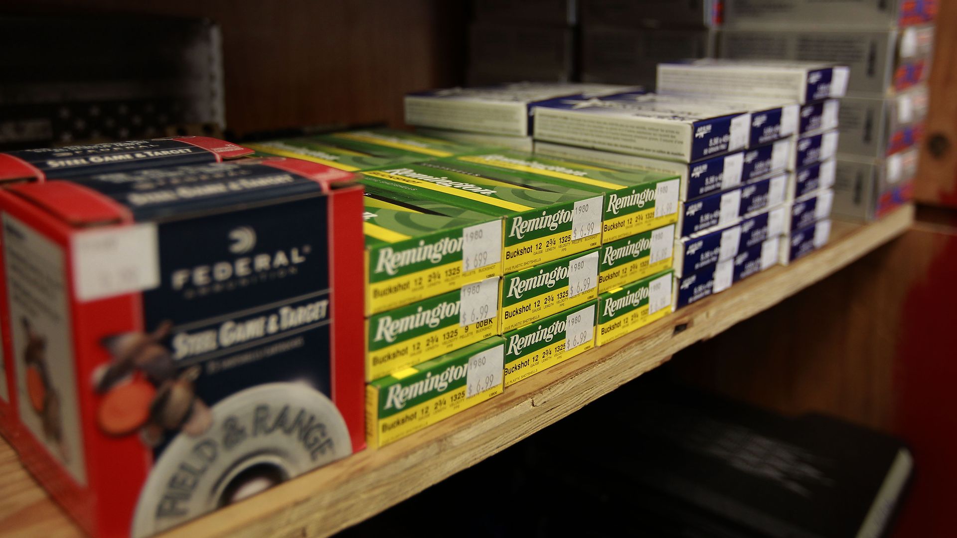 A shelf hold a variety of ammunition.