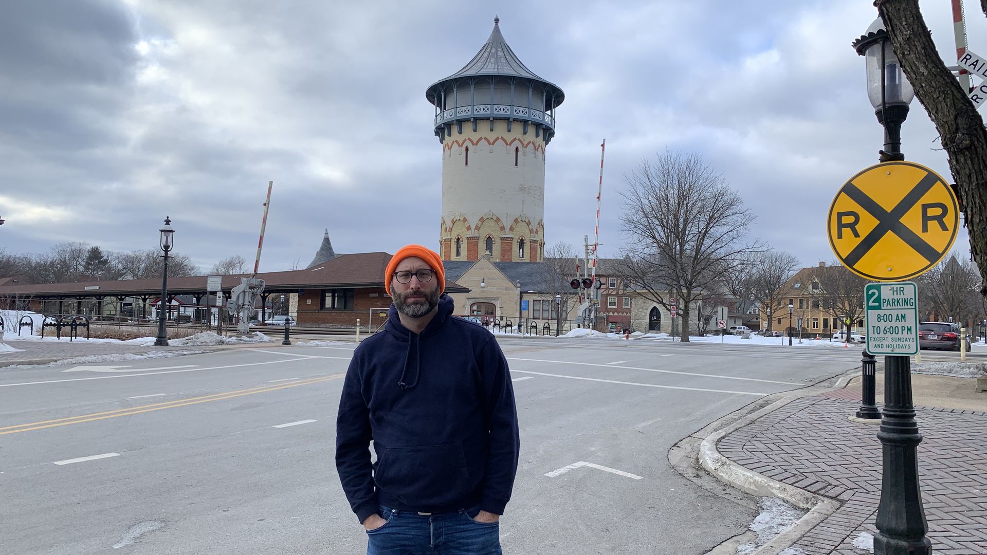 Photo of a man in front of a train station. 