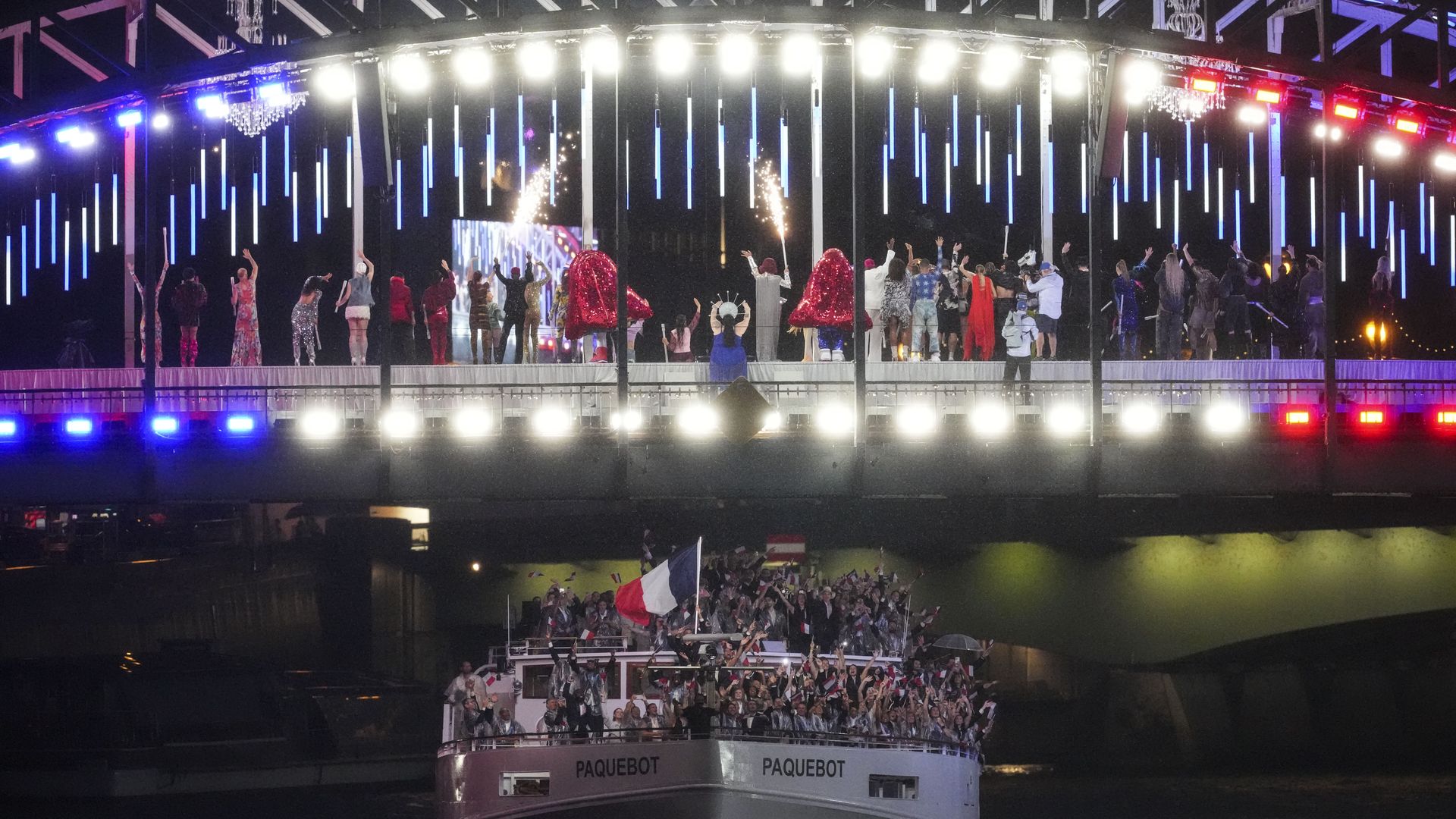 PARIS, FRANCE - JULY 26: Members of Team France are seen on a boat waving their flags along the River Seine during the opening ceremony of the Olympic Games Paris 2024 on July 26, 2024 in Paris, France. (Photo by Bai Yu/CHINASPORTS/VCG via Getty Images)