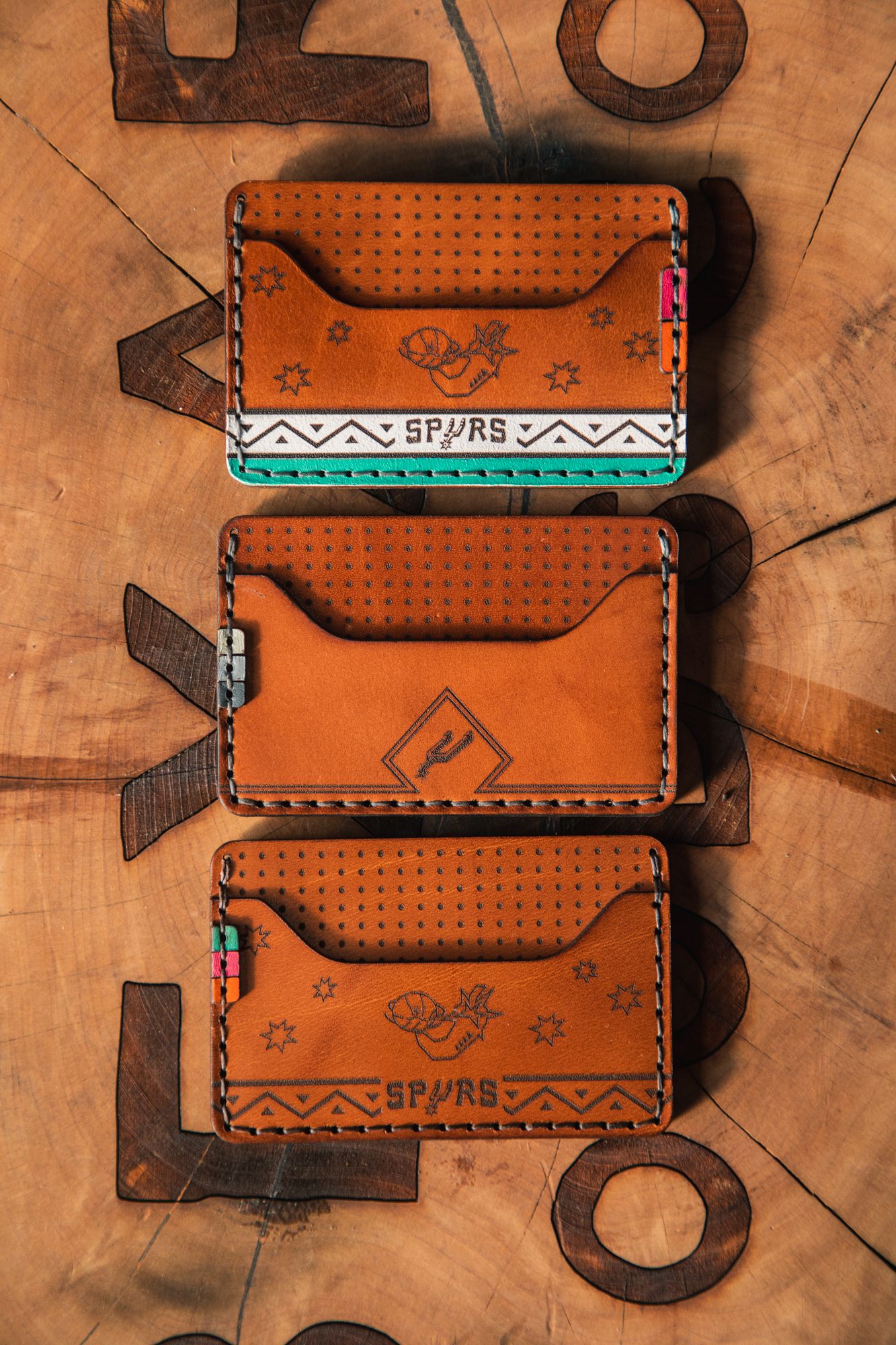 Three wallets arranged in a vertical line. 