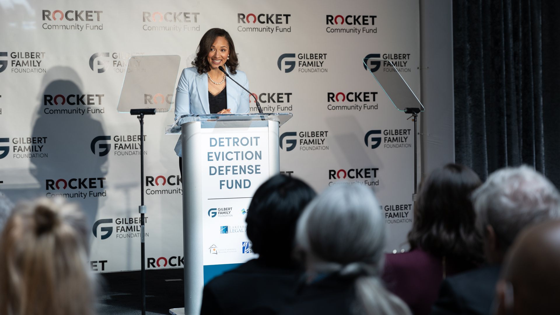 Council President Mary Sheffield smiles while speaking at a lecturn. 