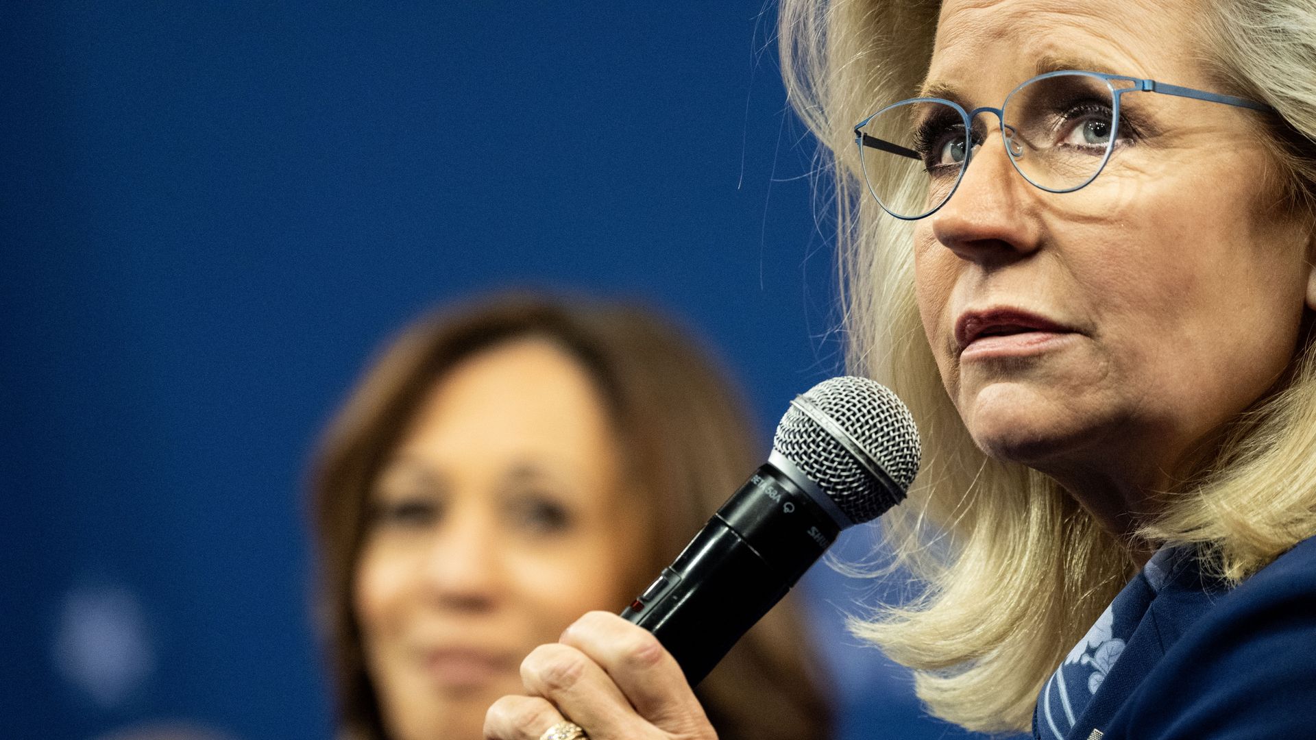 Liz Cheney in the foreground and Kamala Harris in the background. 