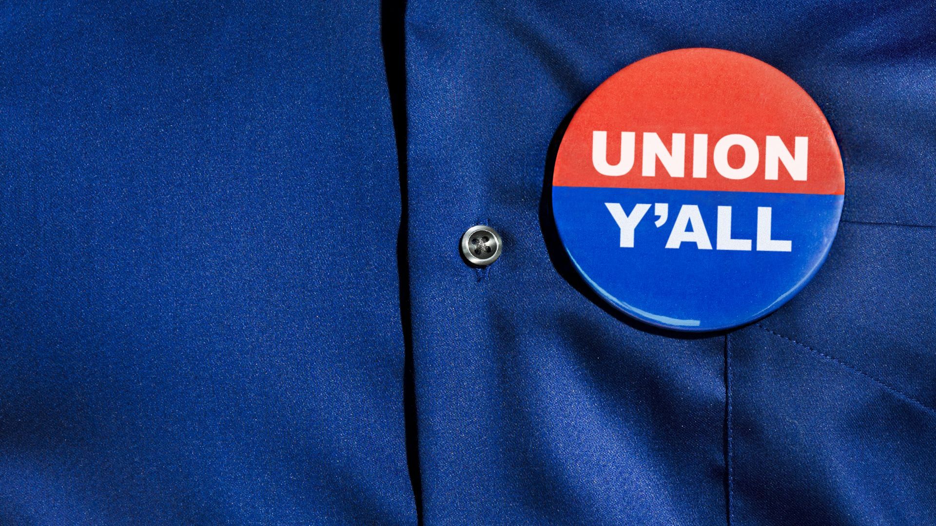 Illustration of a "Union Y'all" two color pin on a button up shirt