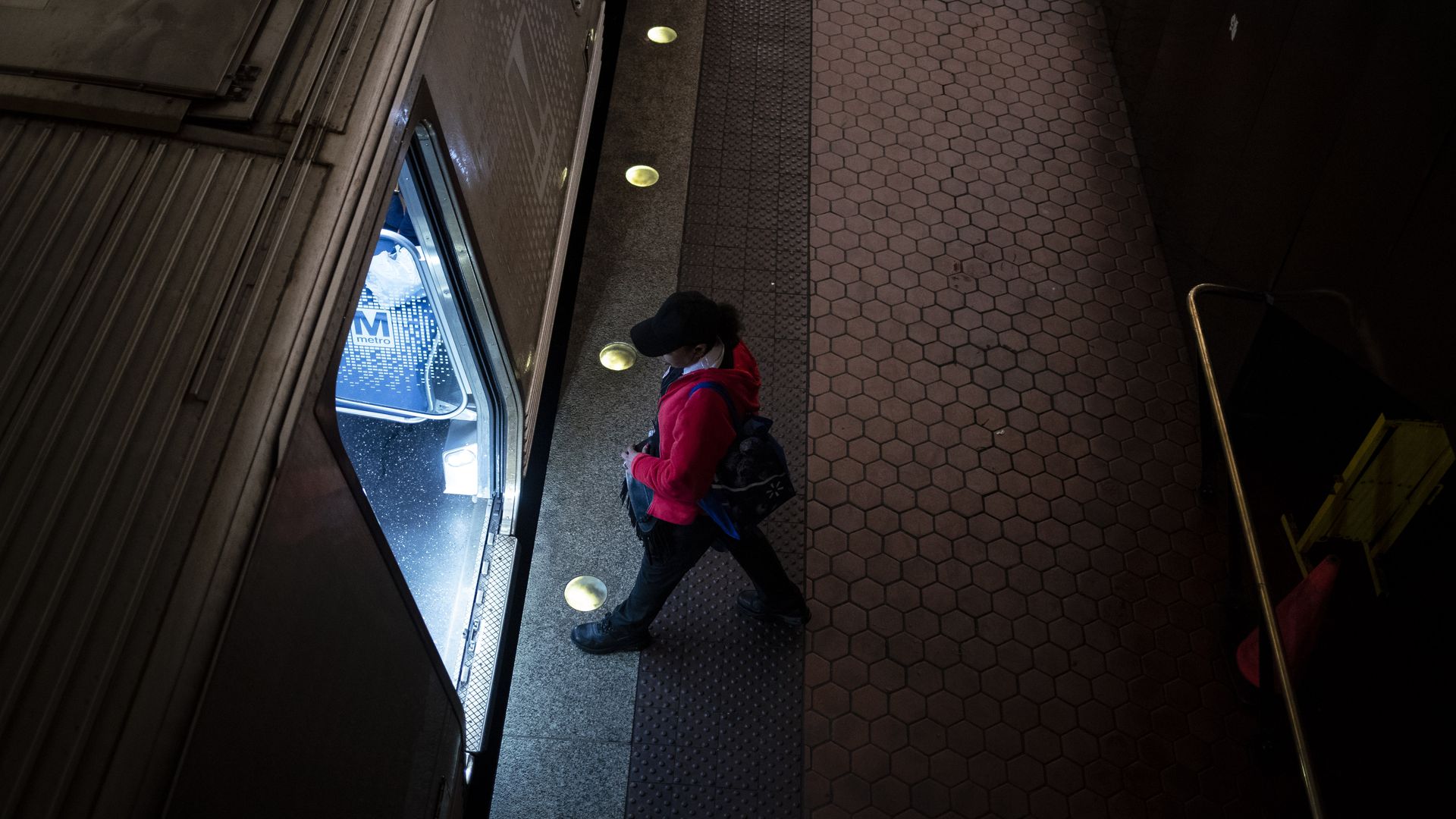 Person viewed from above walking into Metro train