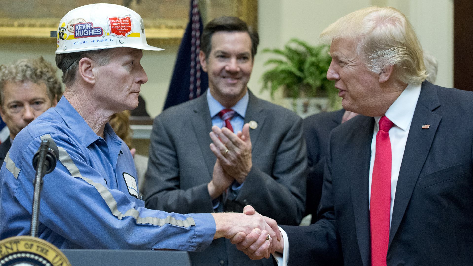 Trump shaking hands with a coal miner