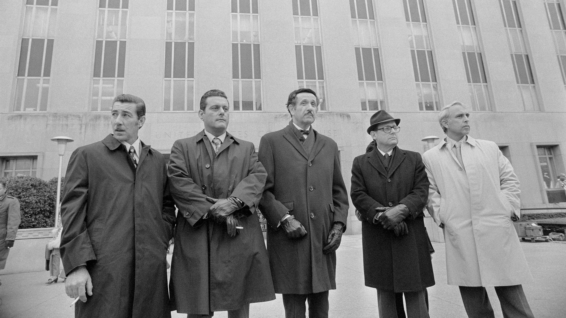 Defendants charged with breaking into the DNC offices at the Watergate complex stand outside with their attorney. Virgilio Gonzales, Bernard Barker, and Eugenio Martinez are among the men.