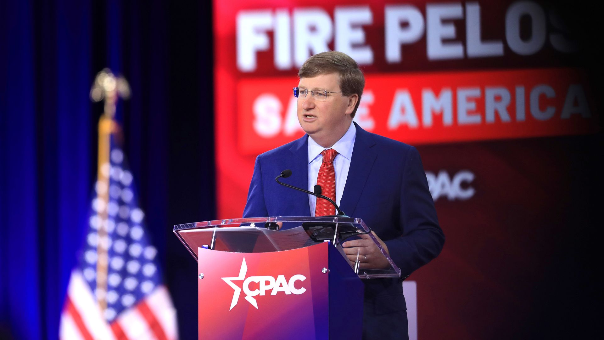 Photo of Tate Reeves speaking from a podium on a CPAC stage