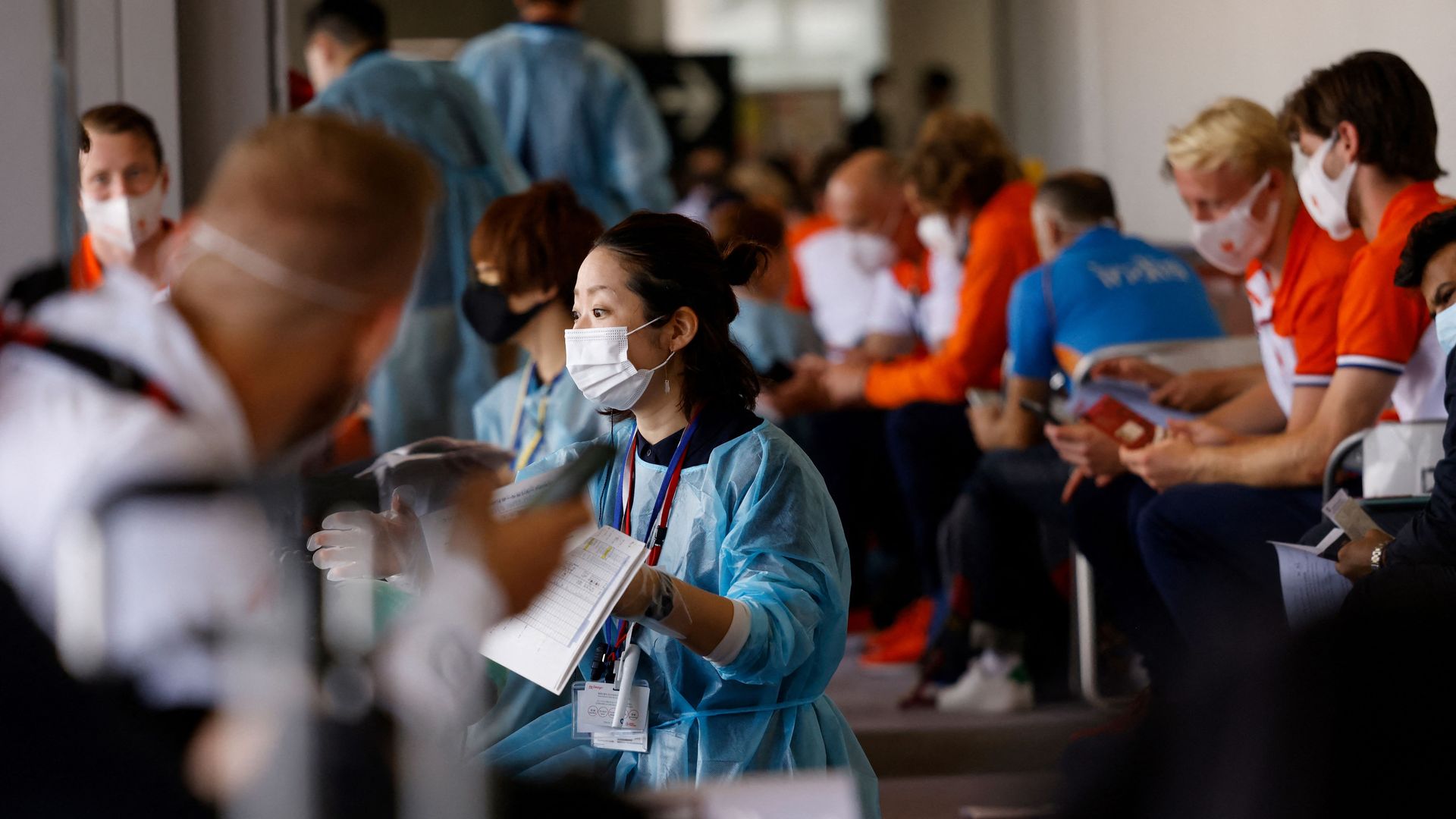 Members of the Netherlands delegation wait for screening and Covid testing upon their arrival in Tokyo on a flight from Amsterdam.