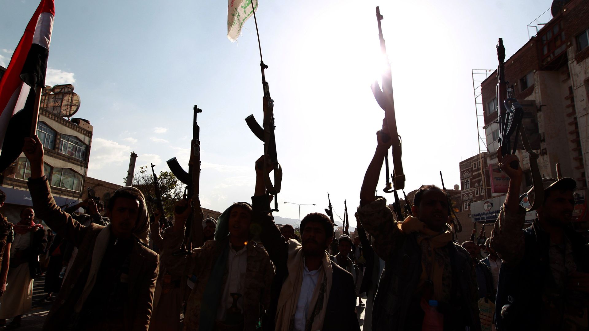 Men raising guns in the air.