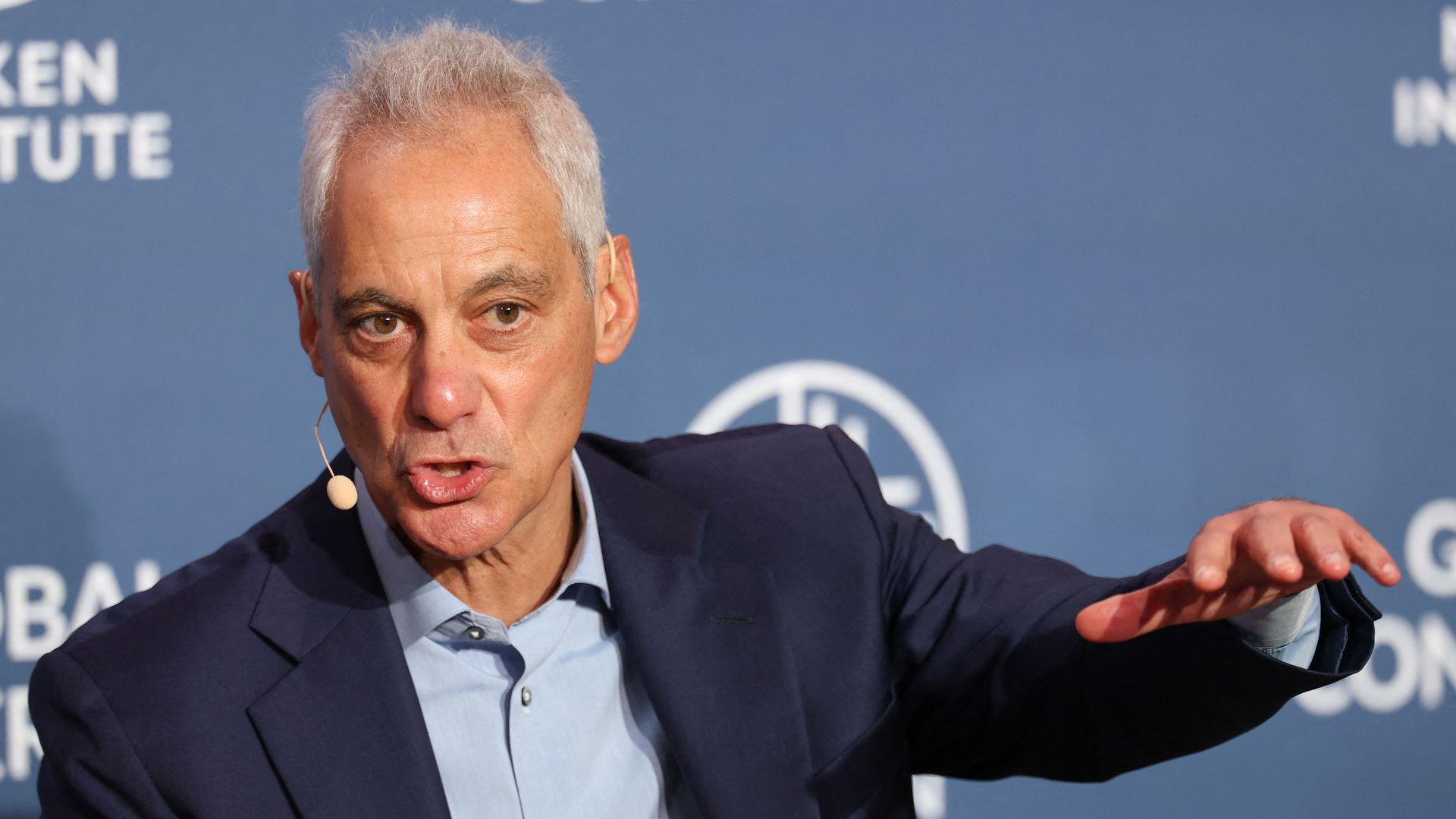 Rahm Emanuel speaks into a headset