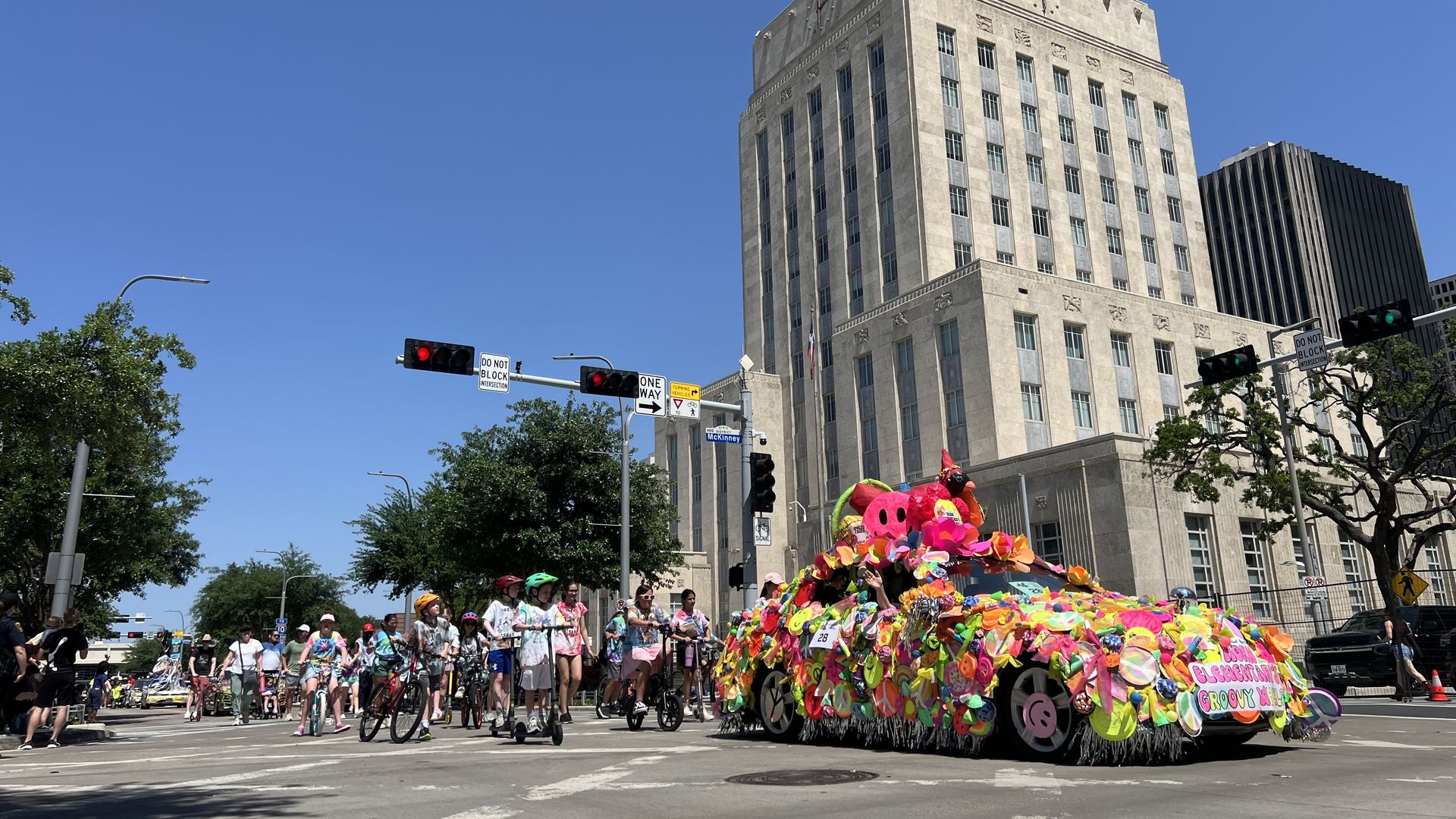 An art car passes Houston City Hall