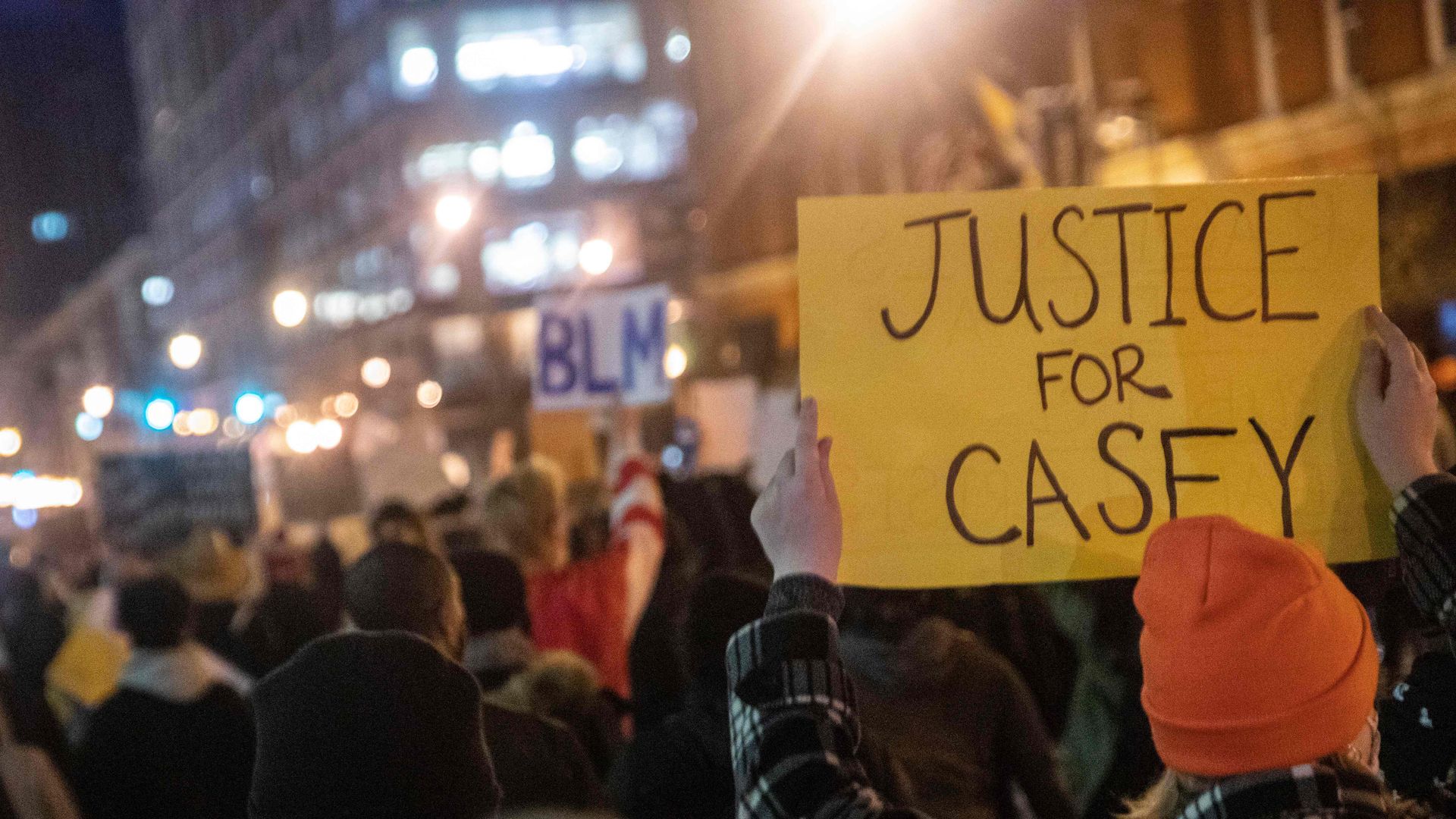 People hold up signs during a march for Casey Goodson Jr. in Columbus, Ohio on December 11, 2020. - Casey Goodson Jr., a 23-year-old Black man, was shot and killed by law enforcement on December 4