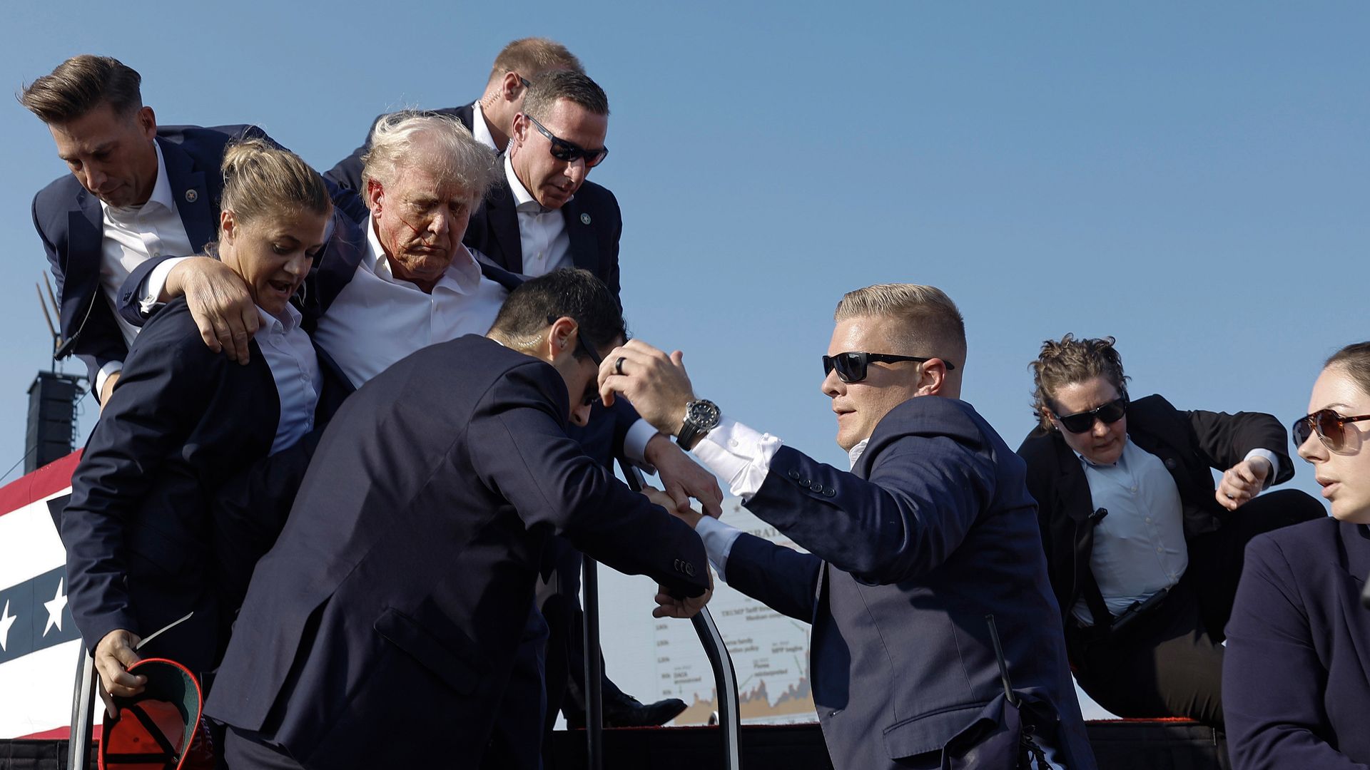 Former President Donald Trump is rushed offstage by U.S. Secret Service agents.
