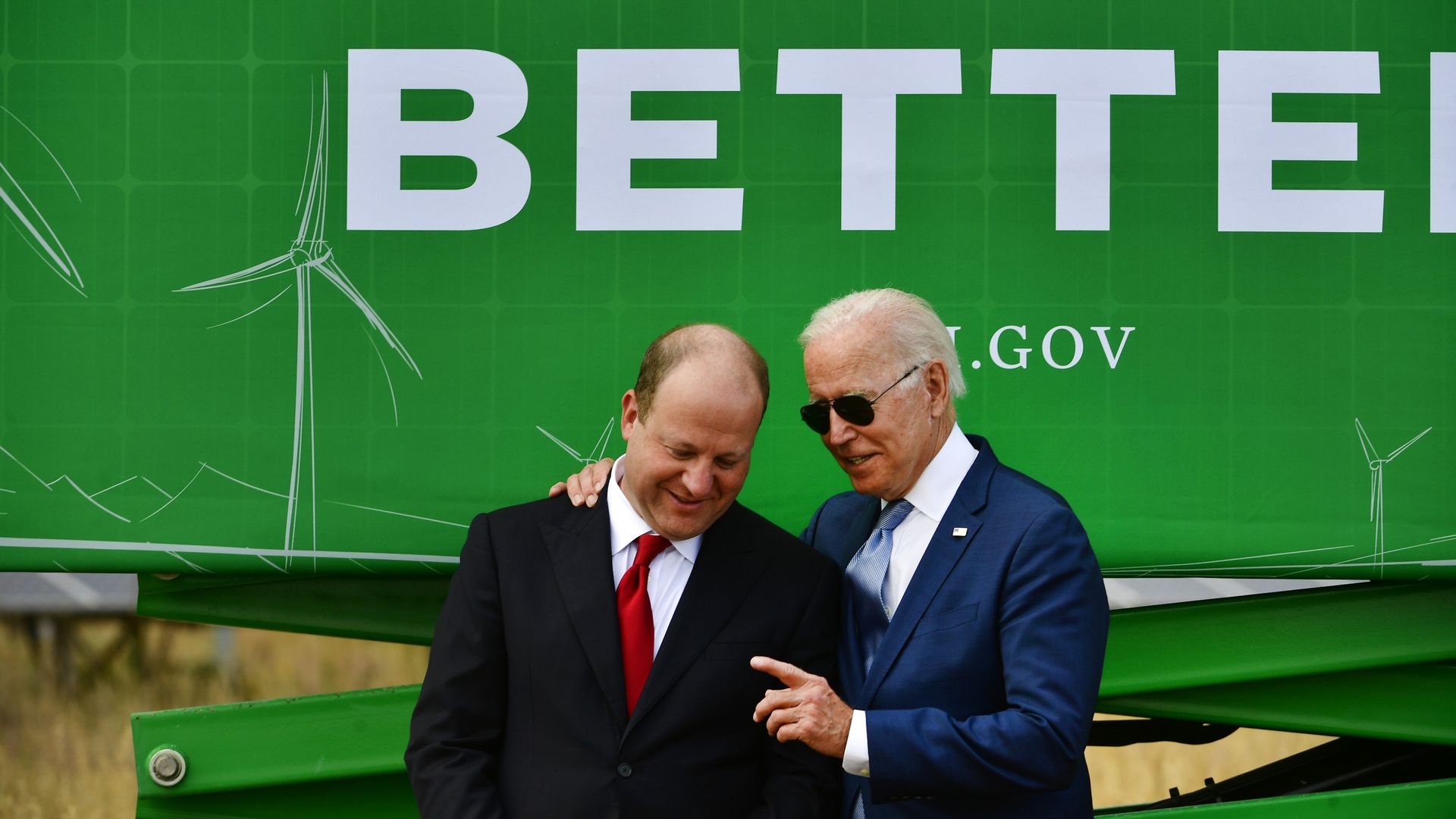 President Joe Biden, right, speaks with Colorado Governor Jared Polis during a September 2021 visit.