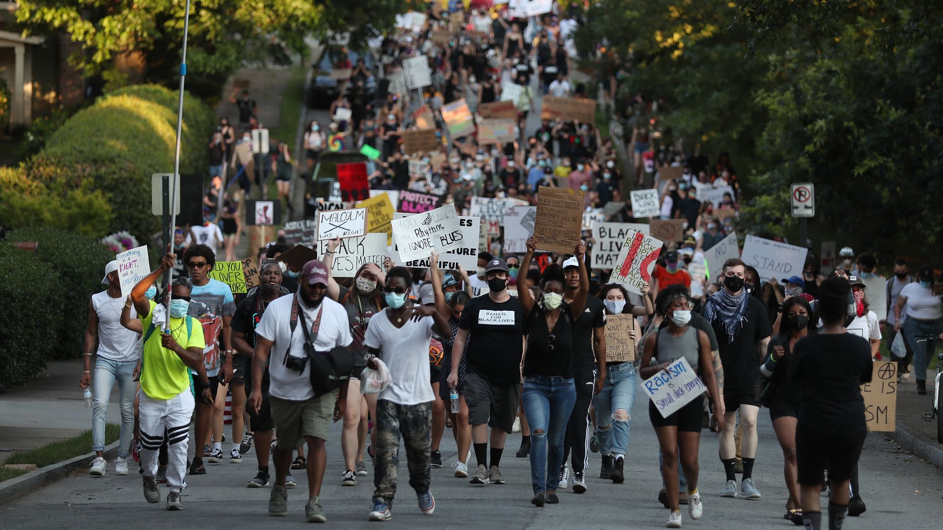 People stretching as far as the eye can see march in the streets against police brutality 