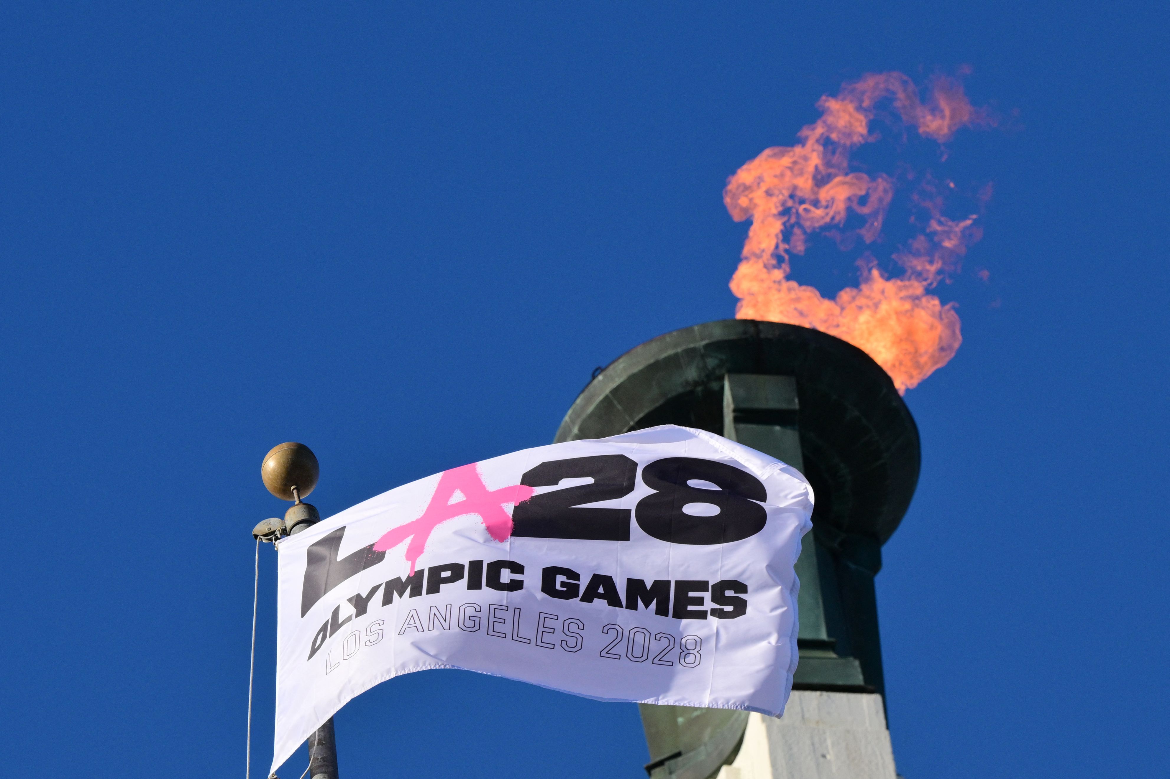 The Olympic cauldron at the historic Los Angeles Memorial Coliseum is lit during a ceremony on Tuesday. Photo: Frederic J. Brown/AFP via Getty Images