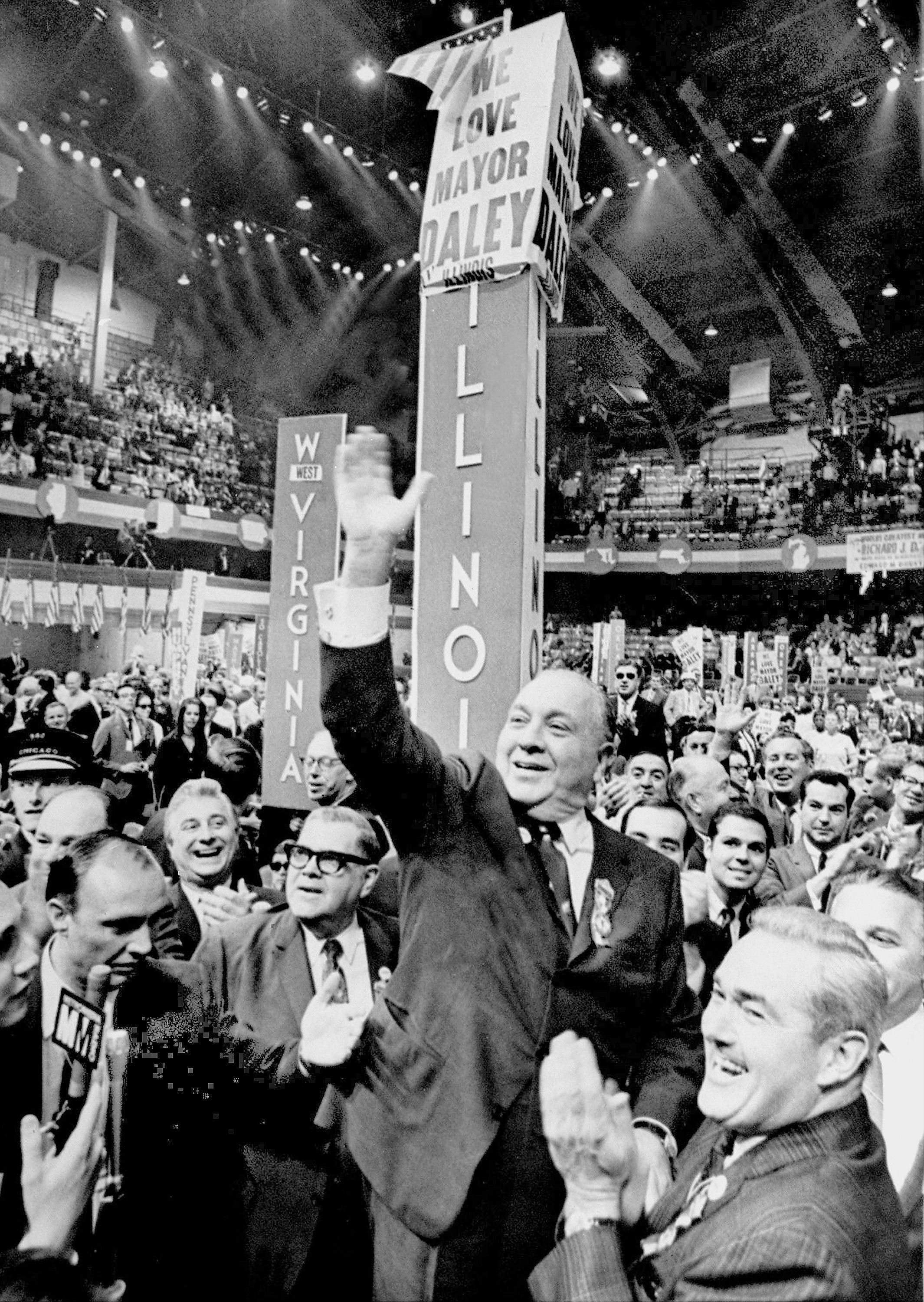 Photo of a man waving at a political convention 