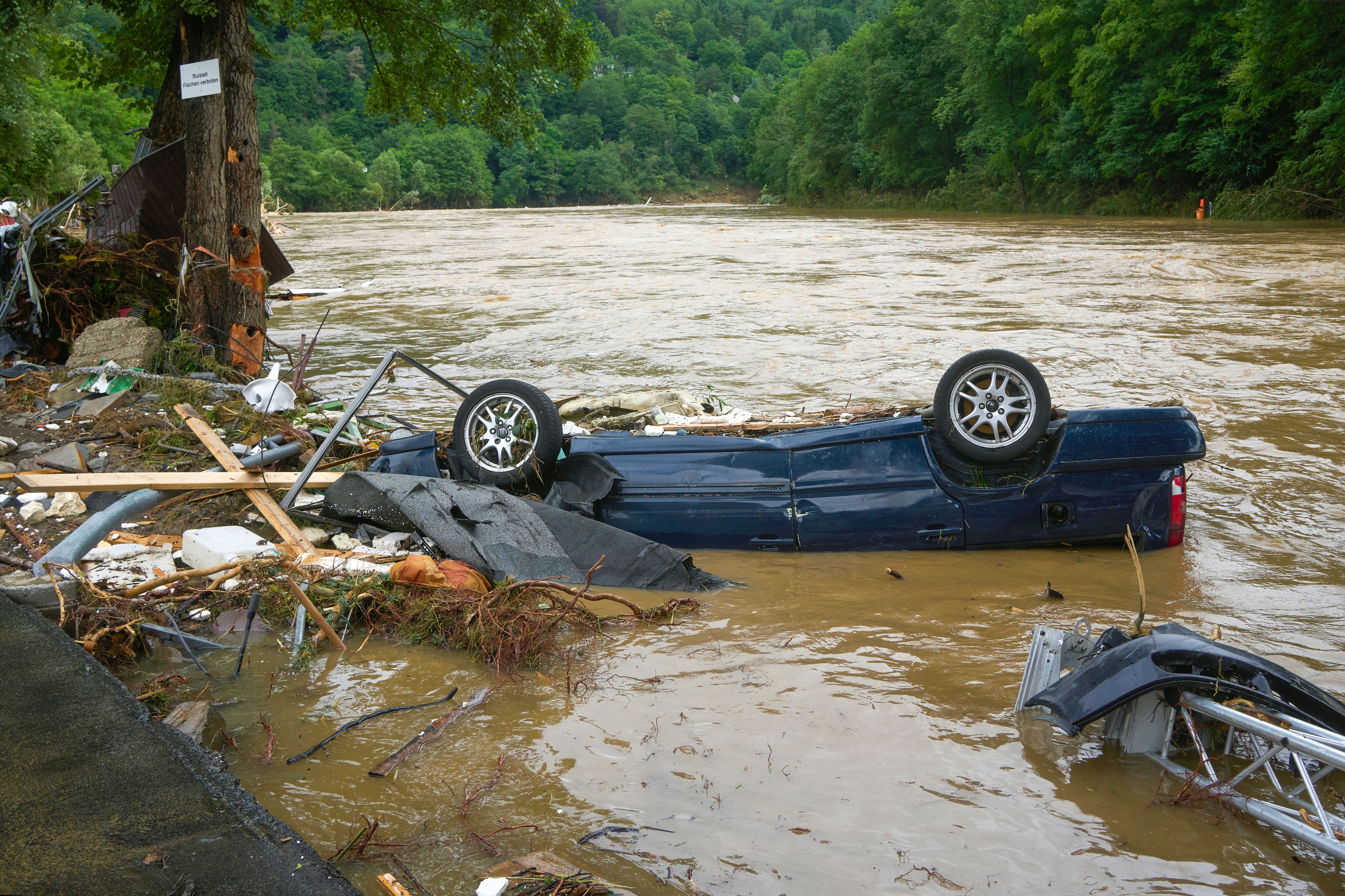 A destroyed car lies in the Ahr river in the village in the district of Ahrweiler.