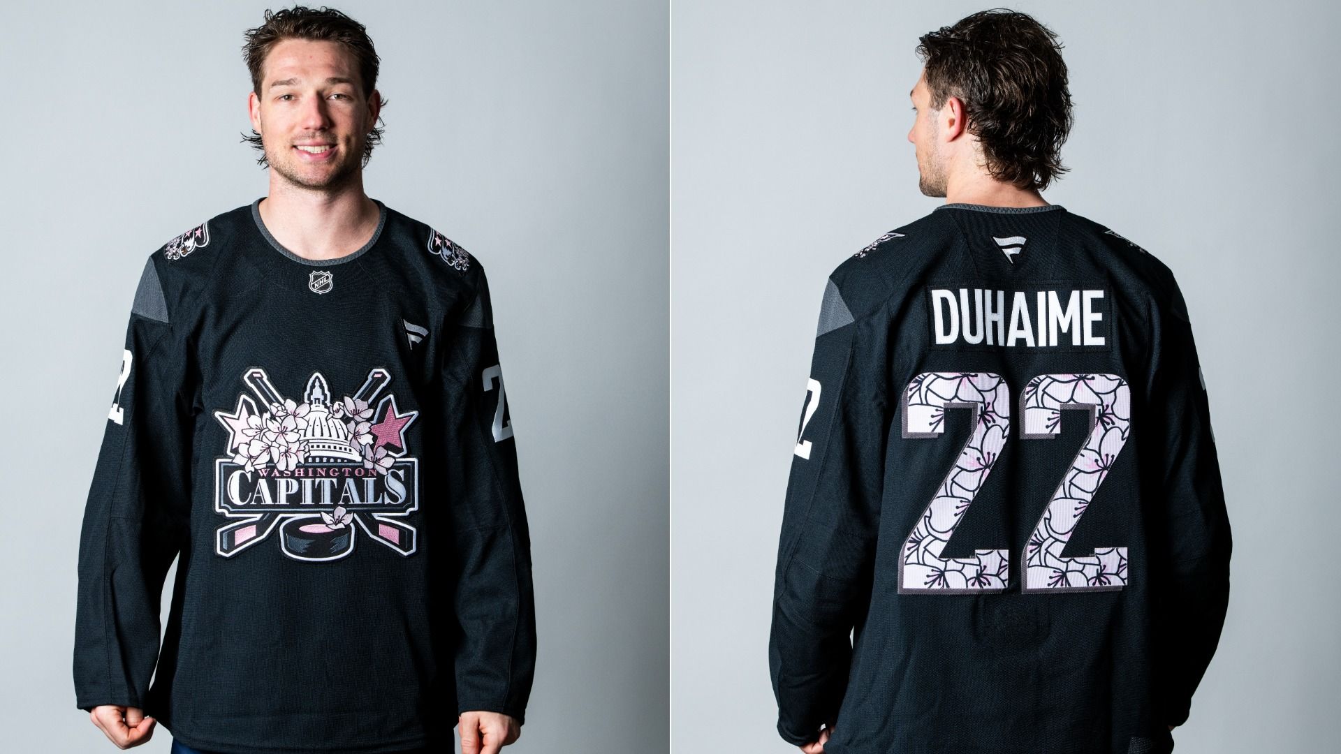 Winger Brandon Duhaime wearing a black Washington Capitals hockey jersey with pink floral designs. Front shows logo, back displays name "DUHAIME" and number 22 with pink flower patterns.