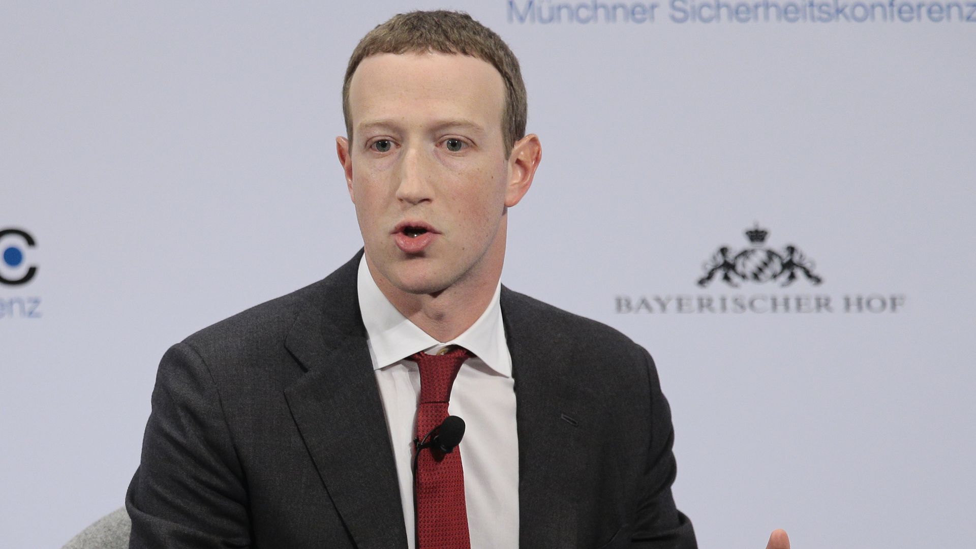 Mark Zuckerberg sits in a suit and tie