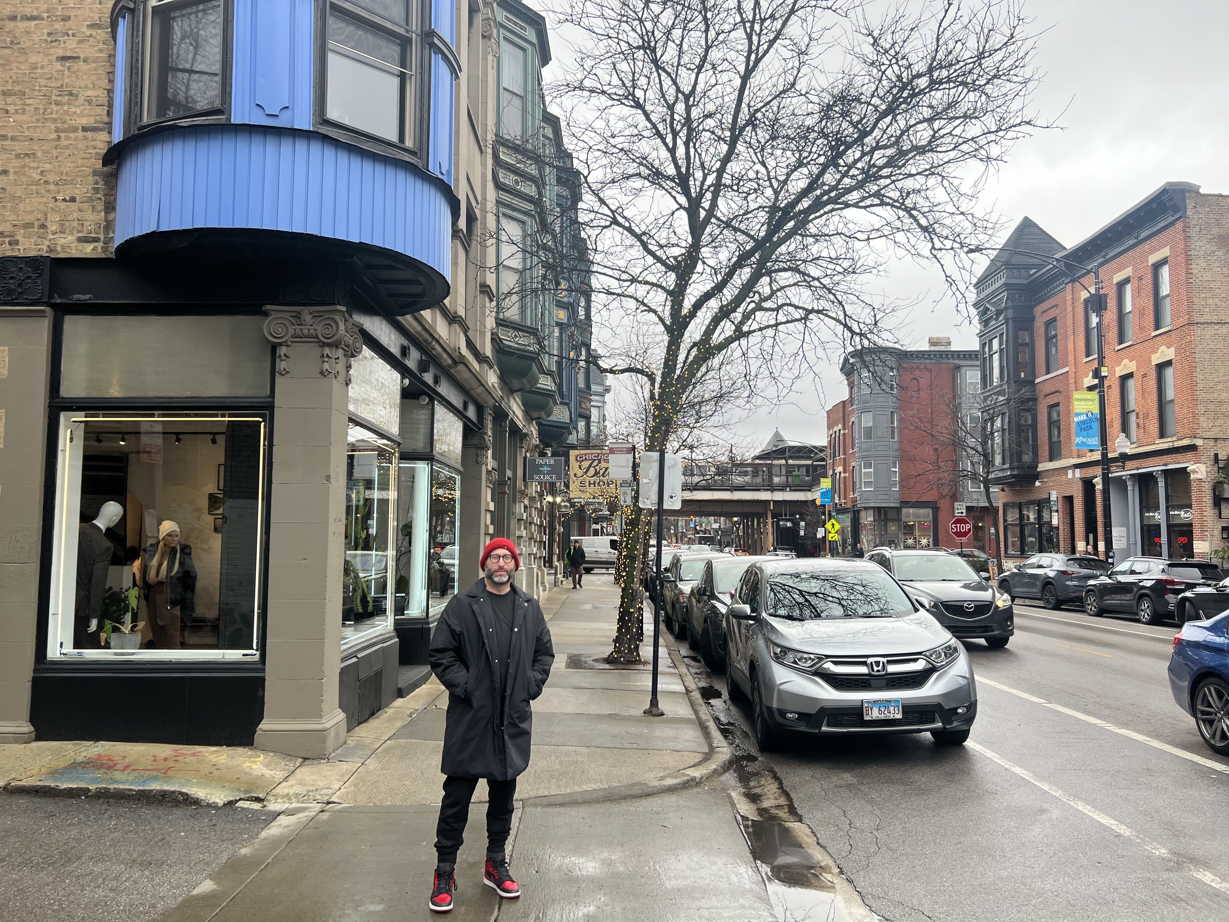 Photo of a man standing on a street 