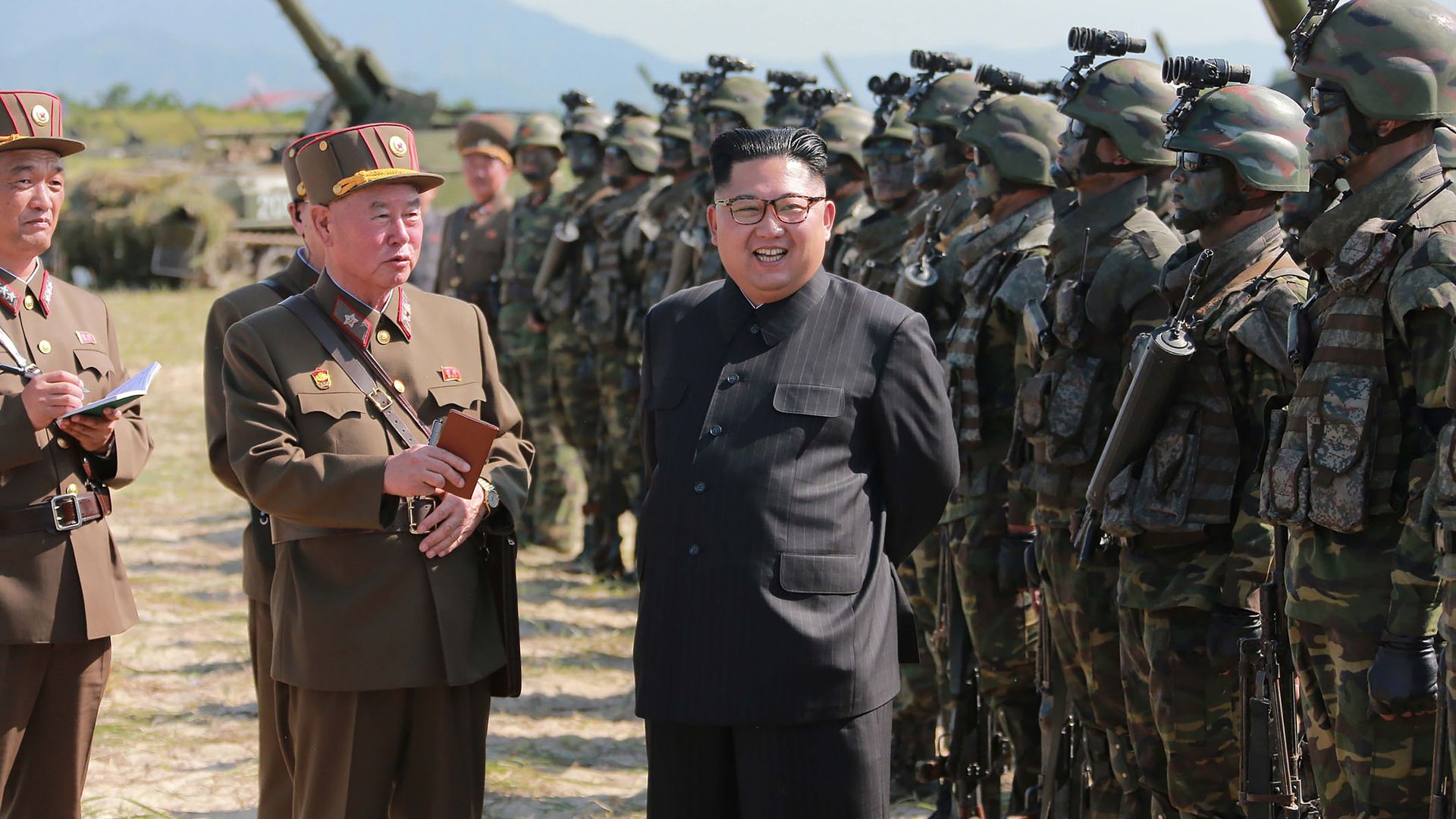 North Korean leader Kim Jong-Un (C) presiding over a target strike exercise