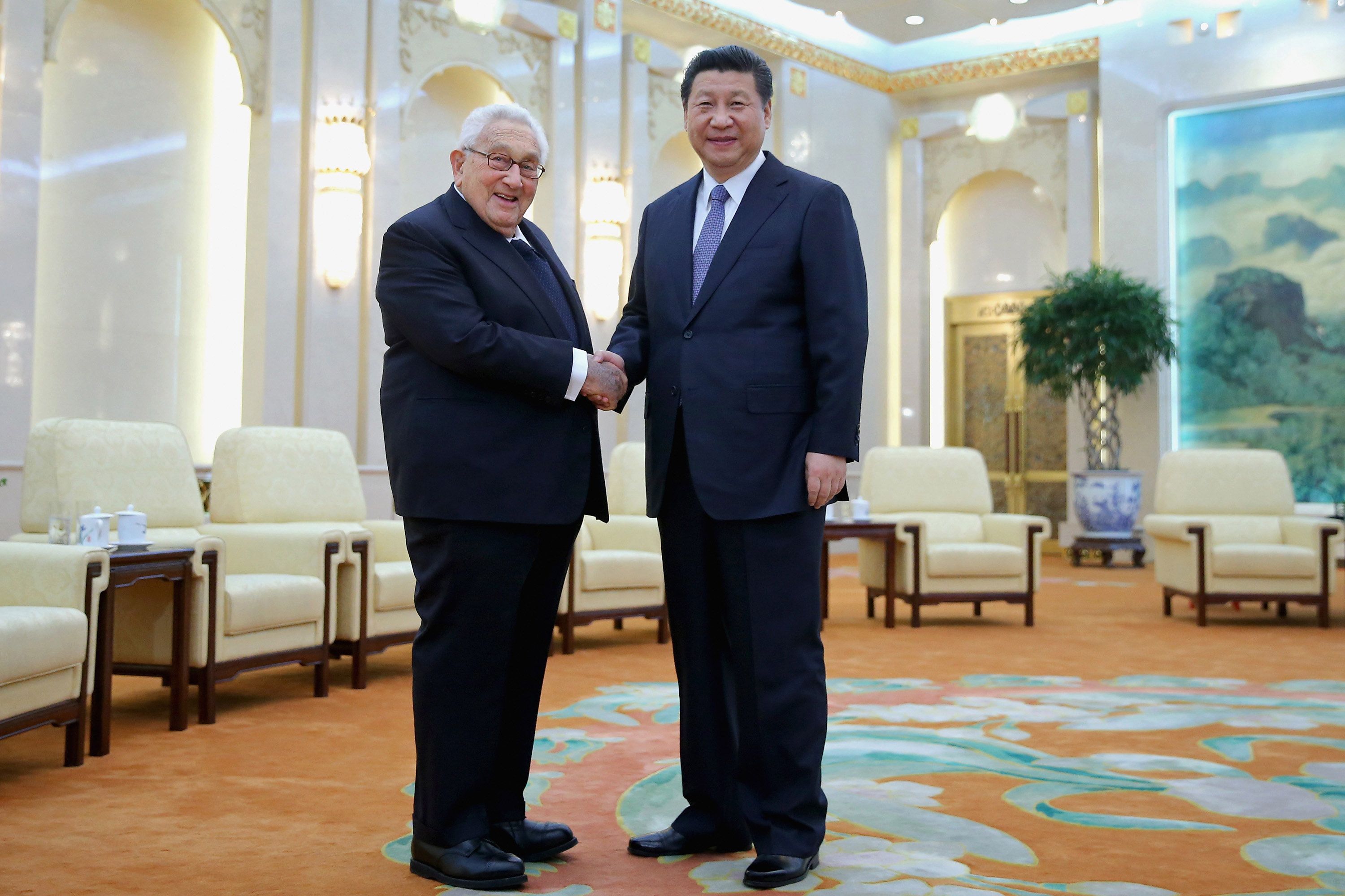 Chinese President Xi Jinping (R) shakes hands with Former United States Secretary of State Henry Kissinger (L) at the Great Hall of the People on March 17, 2015 in Beijing, China.