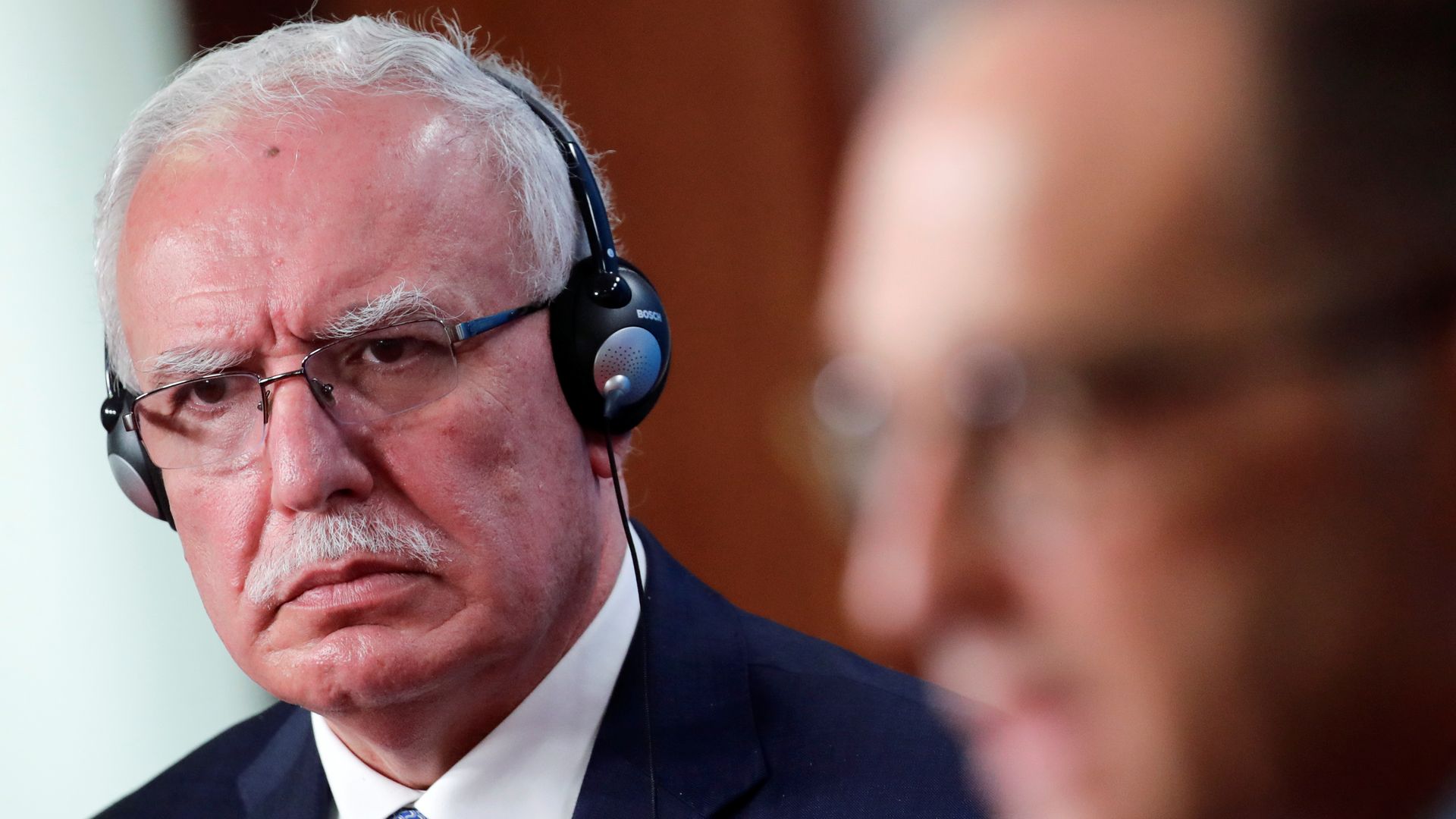 Palestinian Foreign Minister Riyad al-Maliki is seen listening during a news conference.