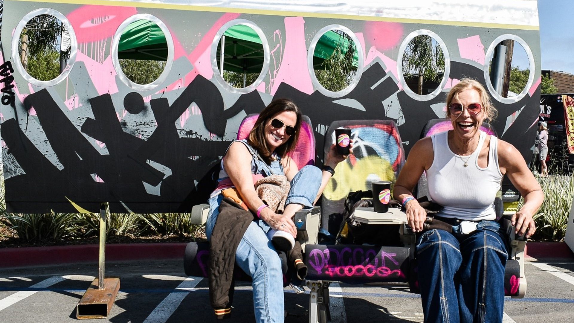 Two festival attendees in front of an art installation 