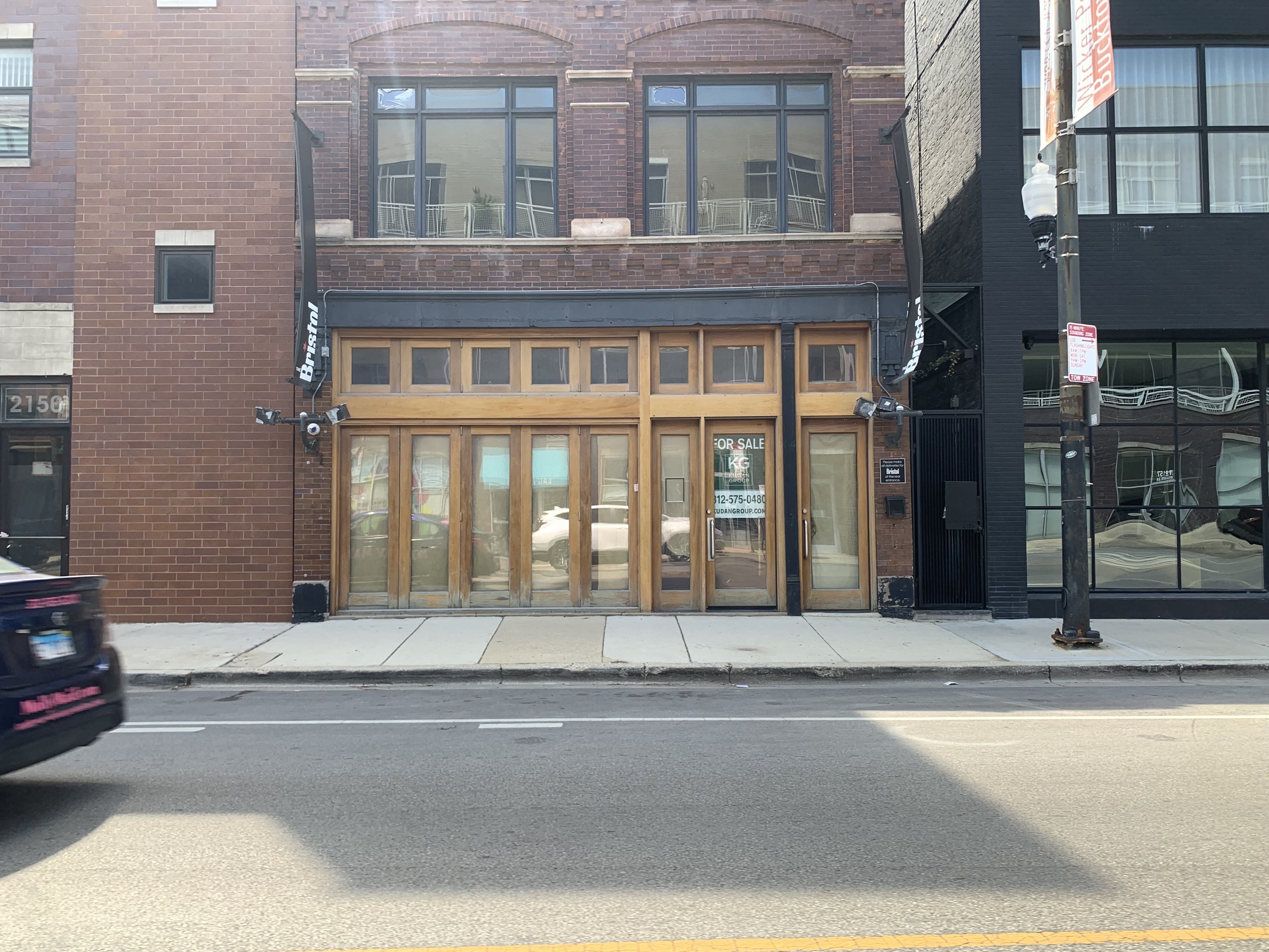 Photo of a boarded up storefront restaurant.