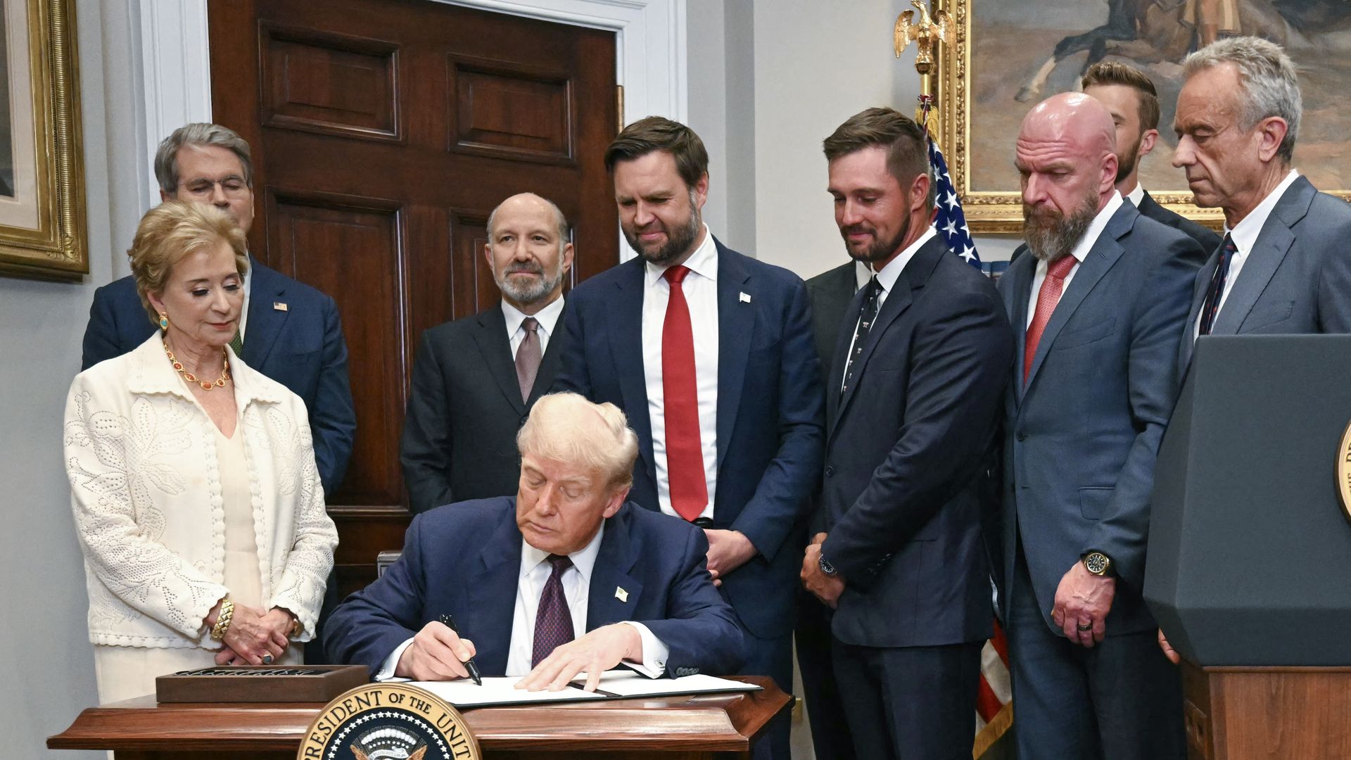  President Trump signs an executive order flanked by US Secretary of Education Linda McMahon in Washington, DC, on July 31, 2025. Photo by Jim WATSON / AFP 