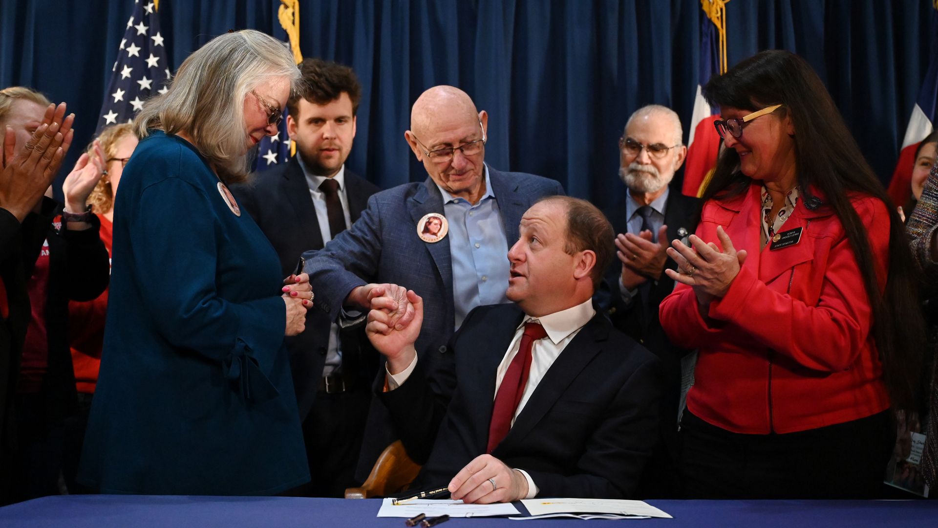 Colorado governor signs 4 major gun bills into law, drawing applause ...