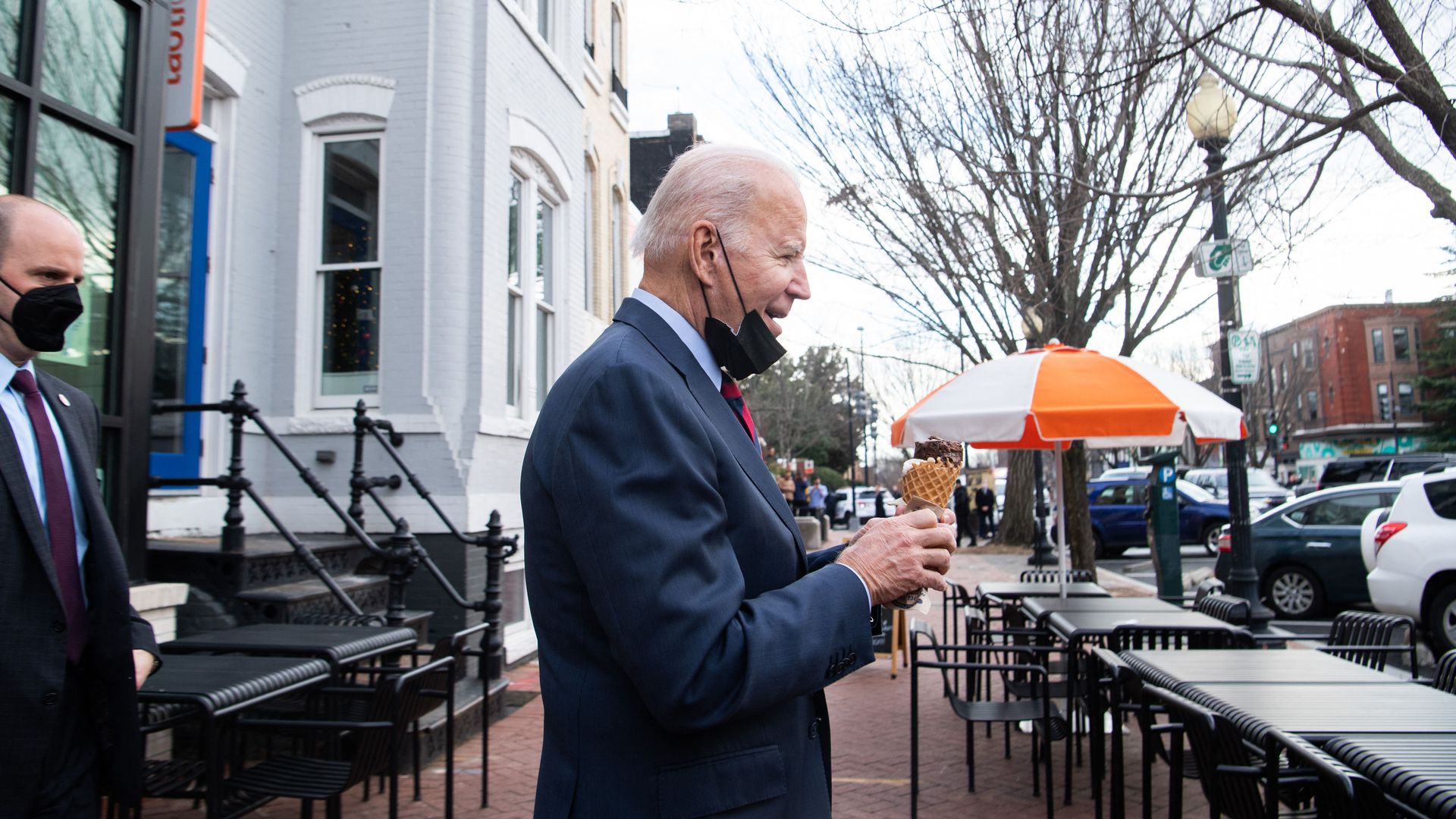 Joe Biden walks out of a store holding an ice cream cone