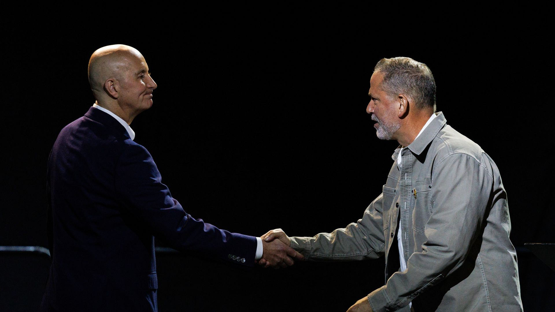 U.S. Sen. Pete Ricketts and Dan Osborn, nonpartisan candidate for U.S. Senate, shake hands after participating in a debate at the Nebraska State Fair in Grand Island on Tuesday, Sept. 1, 2026.