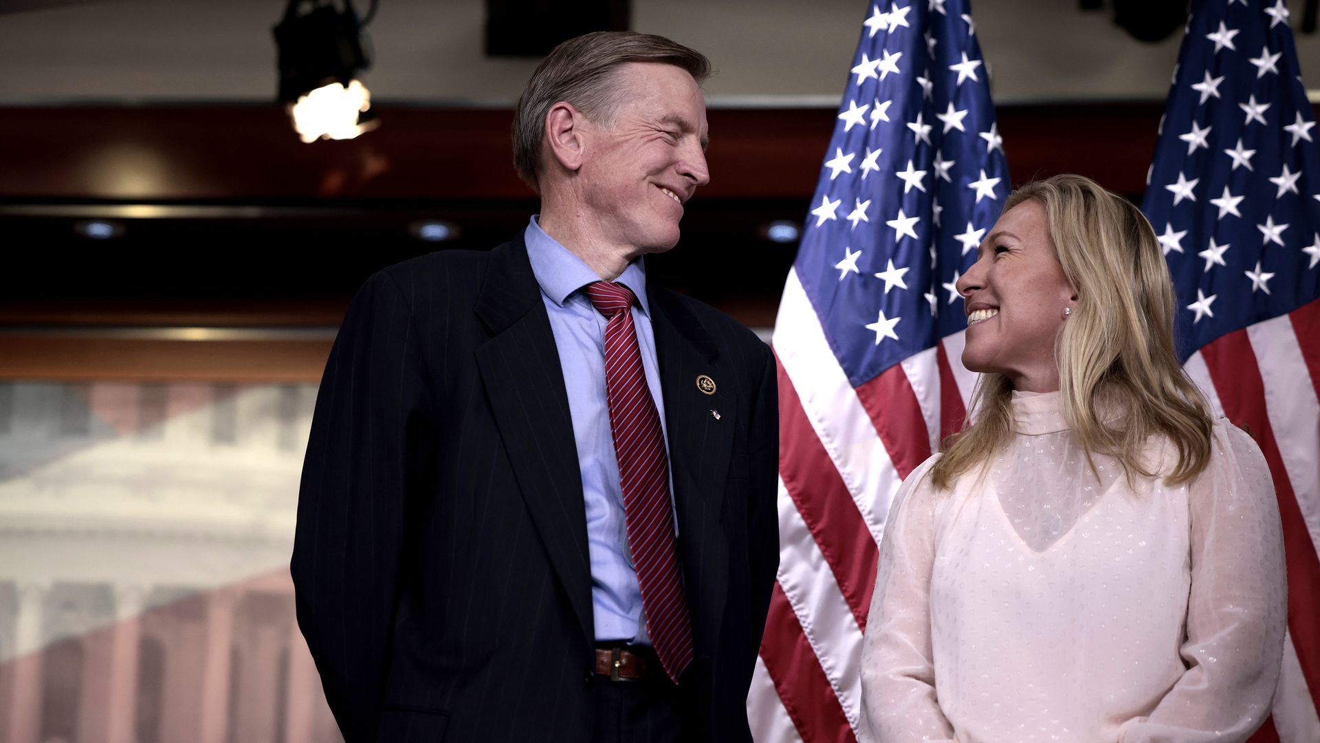 Rep. Marjorie Taylor Greene (R-GA) smiles at Rep. Paul Gosar (R-AZ) during a news conference at the U.S. Capitol Building on December 07, 2021