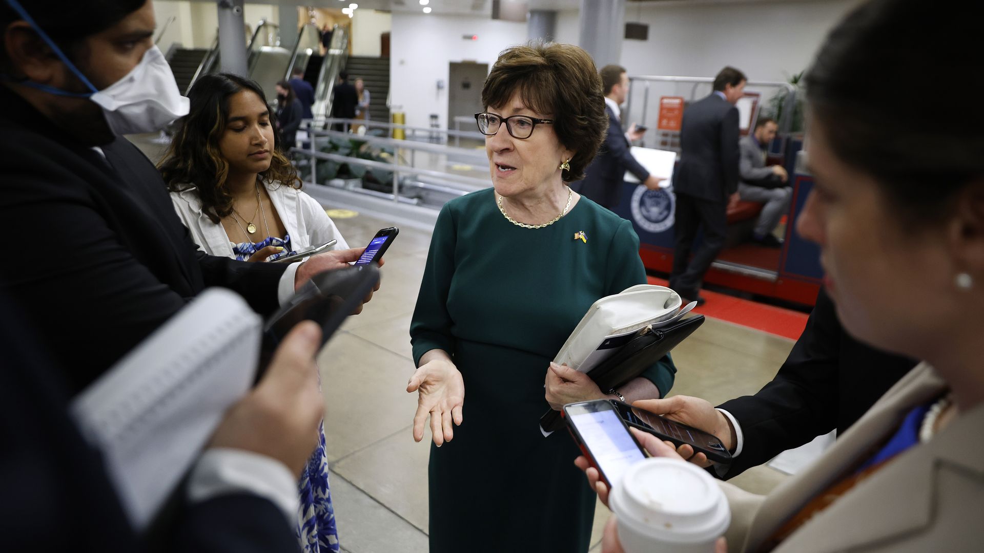 Sen. Susan Collins talks with reporters.