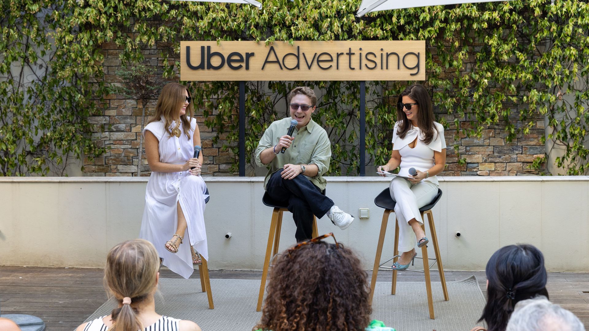 Spotify chief public affairs officer Dustee Jenkins, podcast host Jake Shane and Axios' Sara Fischer on stage in Cannes.