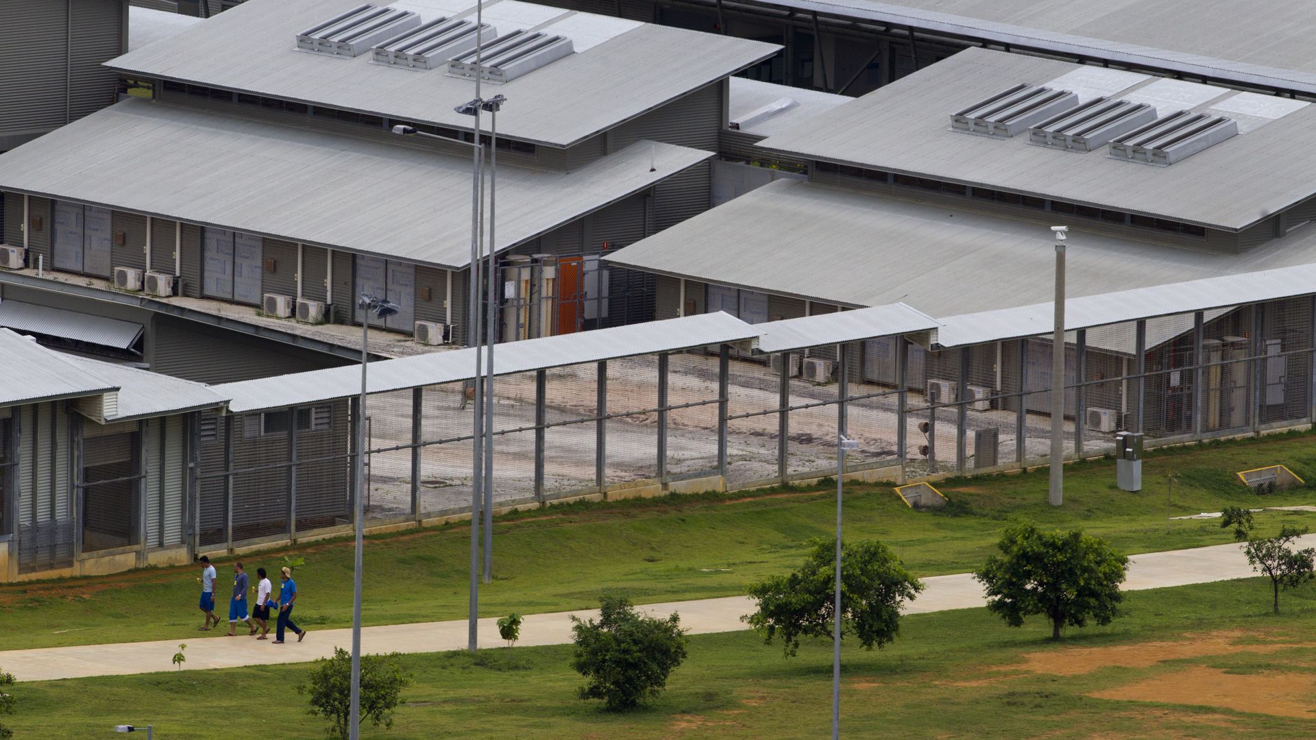 Detainees walk inside the Immigration Detention Center (IDC) compound February 25, 2012 on Christmas Island, Australia.