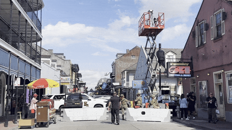 Image shows a man walking through a police barricade.