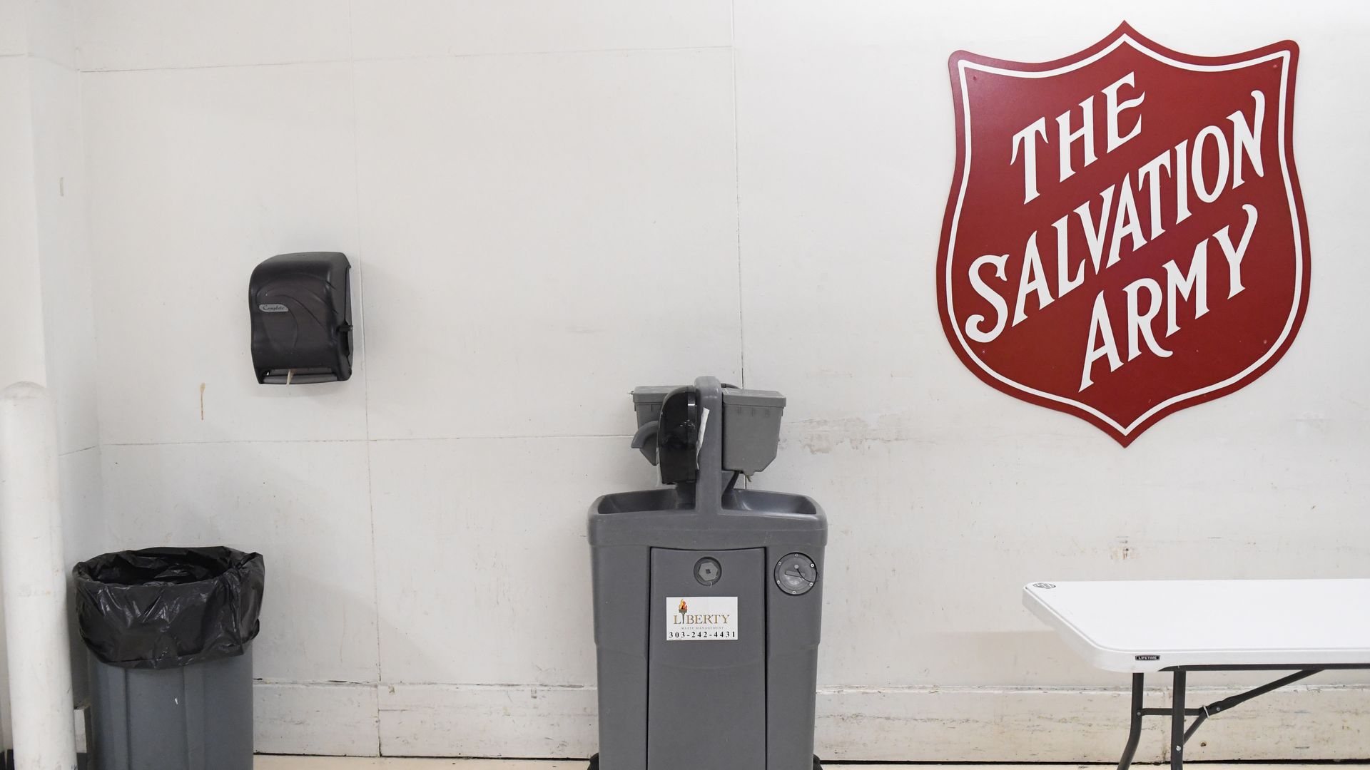A room with cleaning material and a sign reading THE SALVATION ARMY.