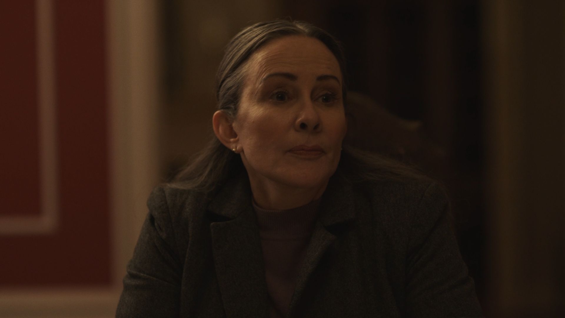 Actress Patricia Heaton sits at a table.