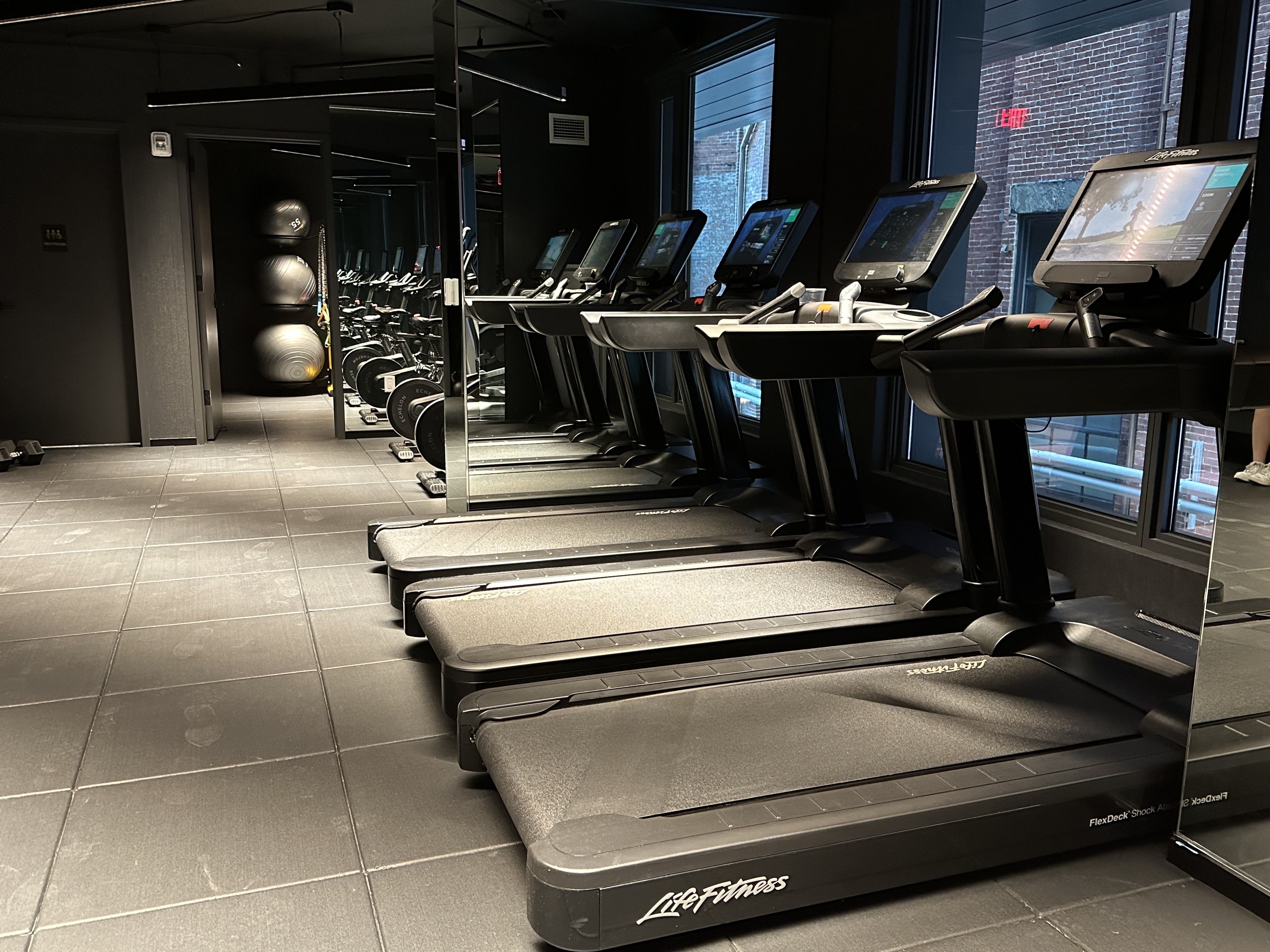 The Gronk Fitness gym at The Parker has a series of LifeFitness treadmills.